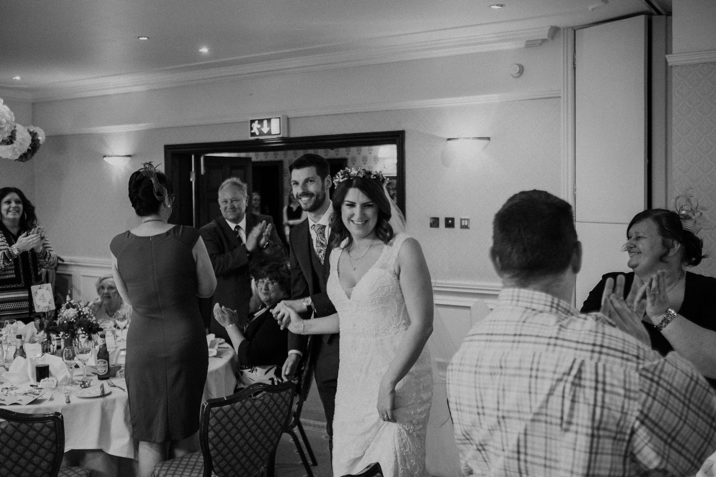 Black and white photo of bride and groom entrance