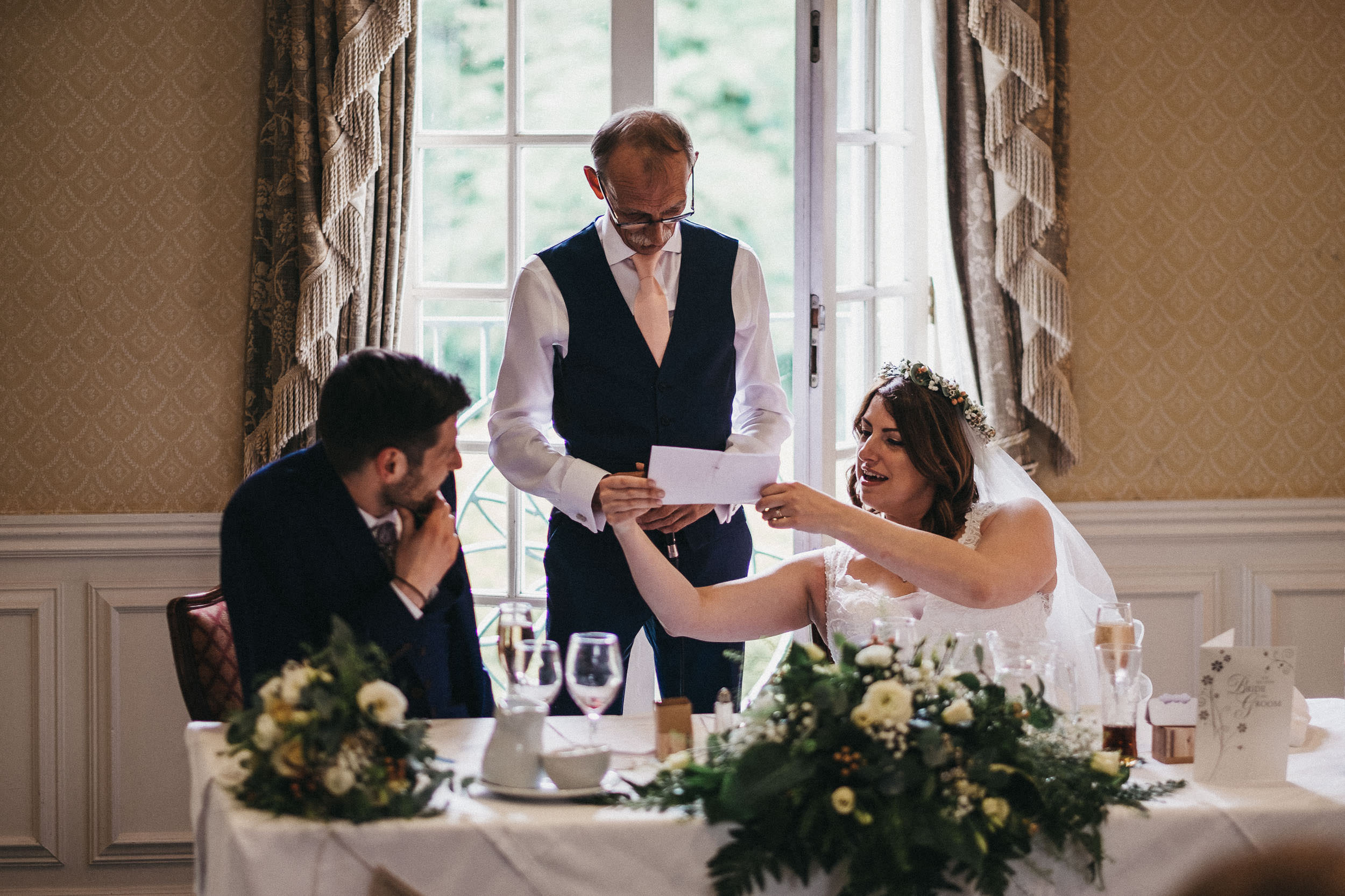 Bride holds up father's speech for him to read