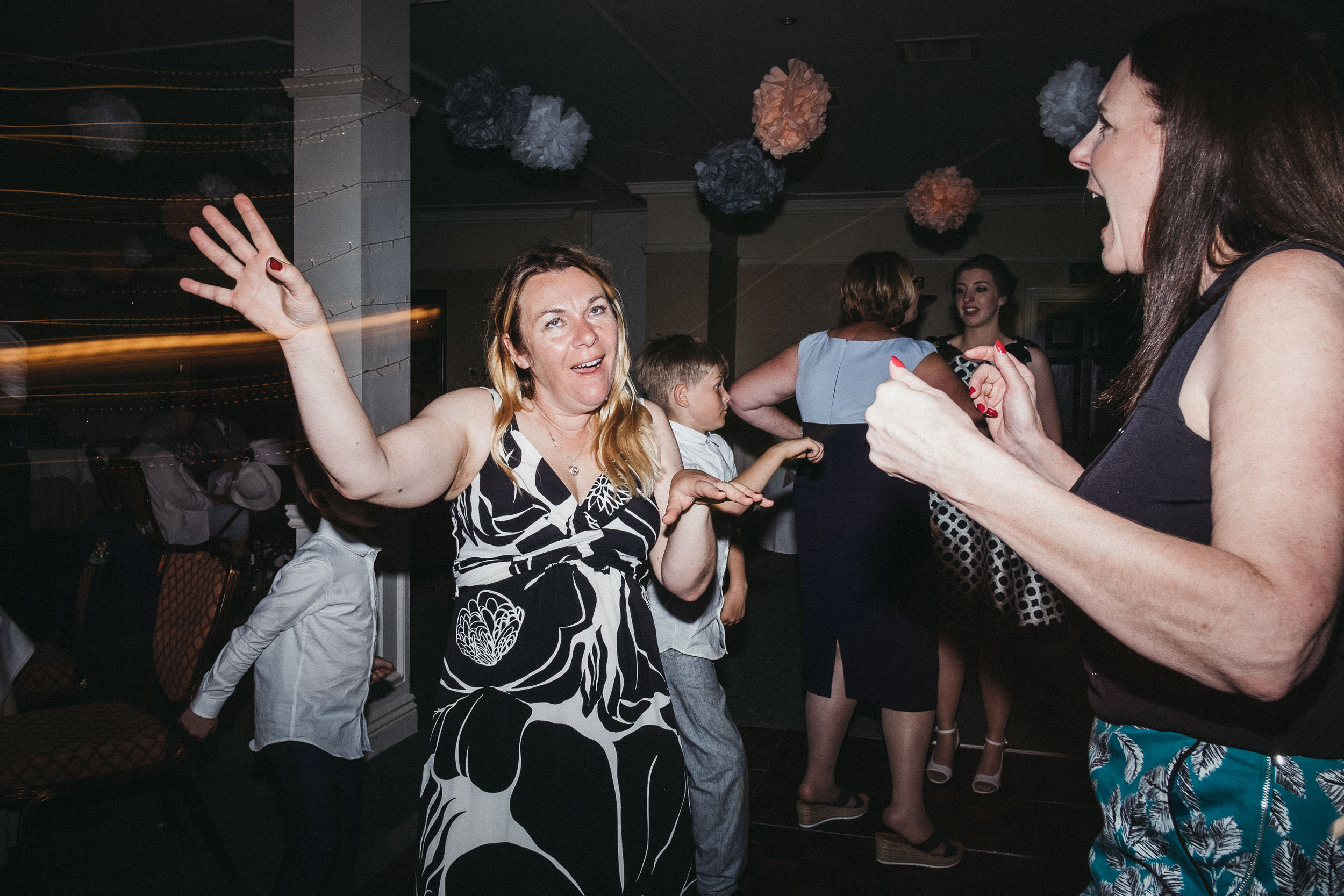 Wedding guest pulls funny face on dance floor