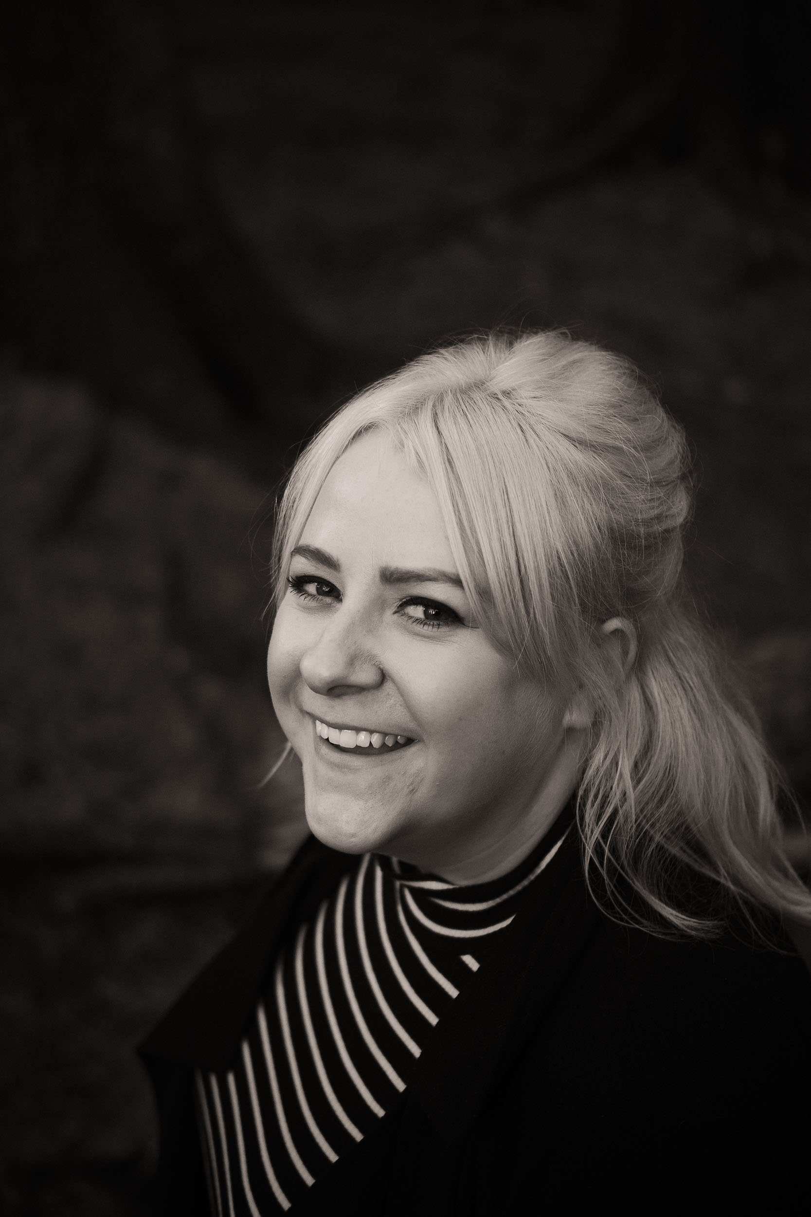 Black and white close up portrait of woman laughing