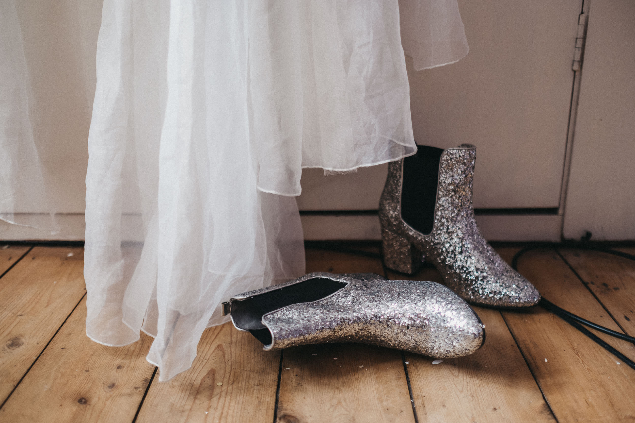 Detail shot of glittery boots under wedding dress