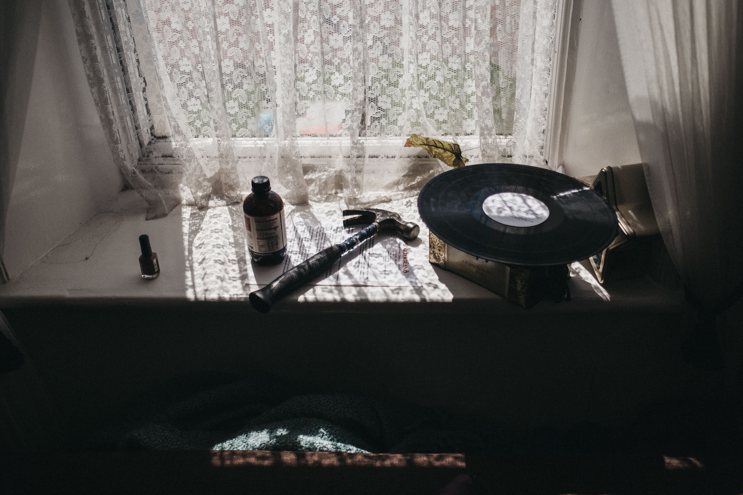 Windowsill with vinyl record and hammer