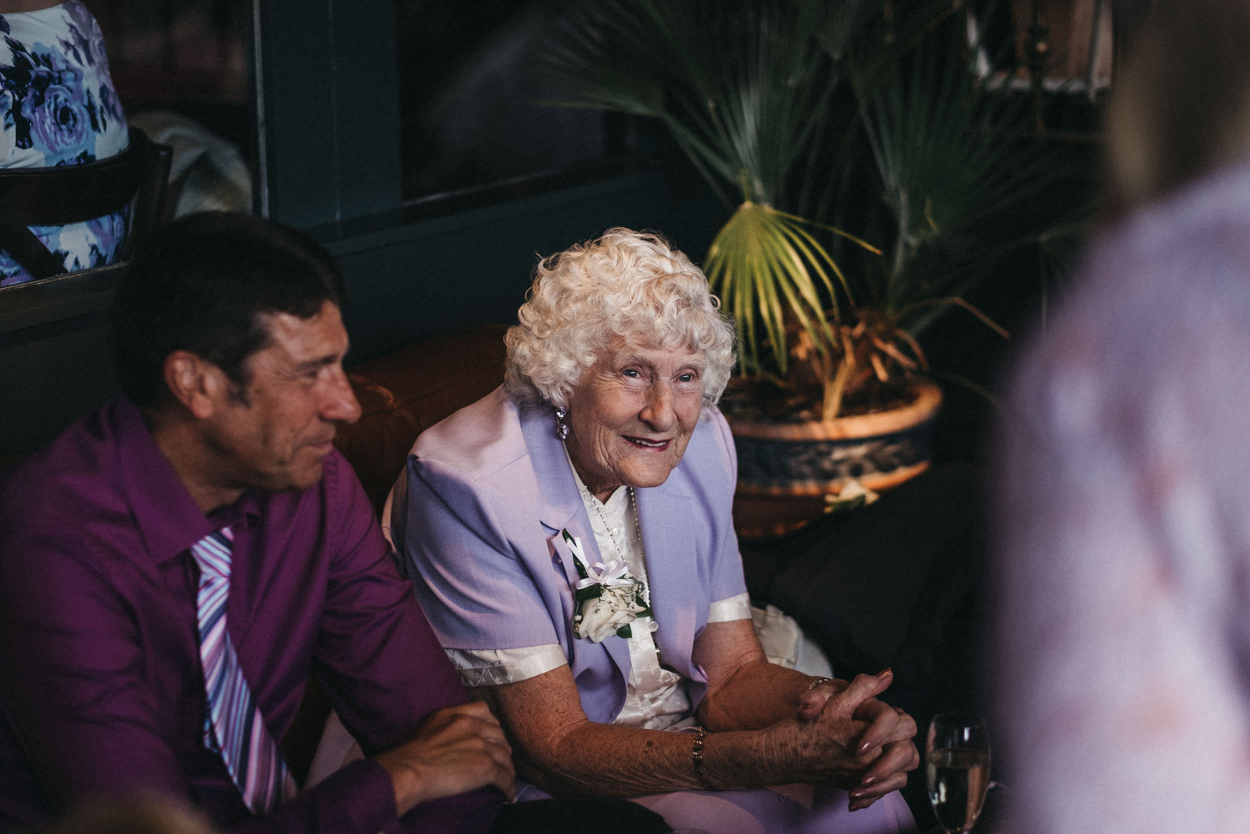 Older guest smiles at As You Like It wedding