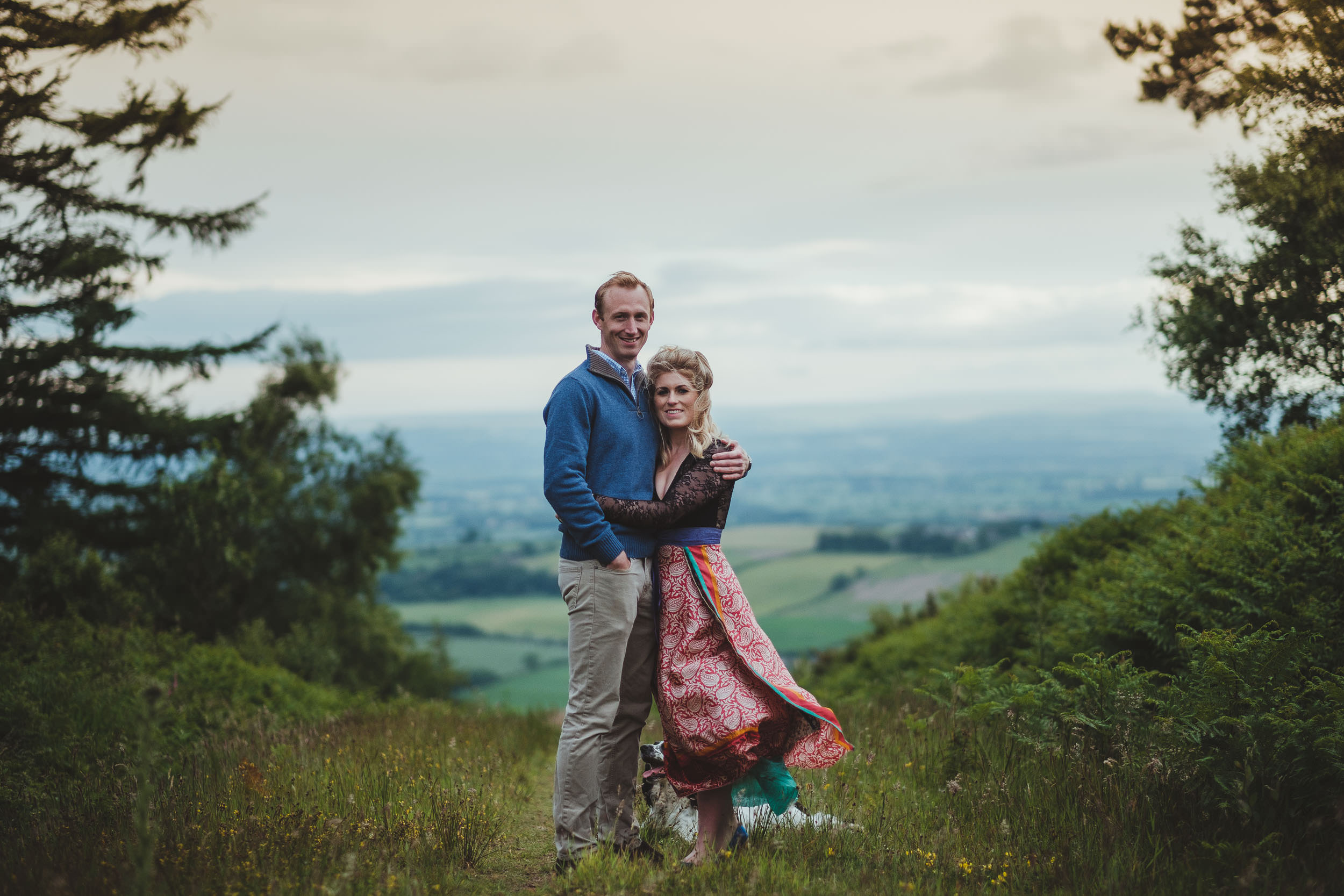 Couple cuddle on path high in Yorkshire hills