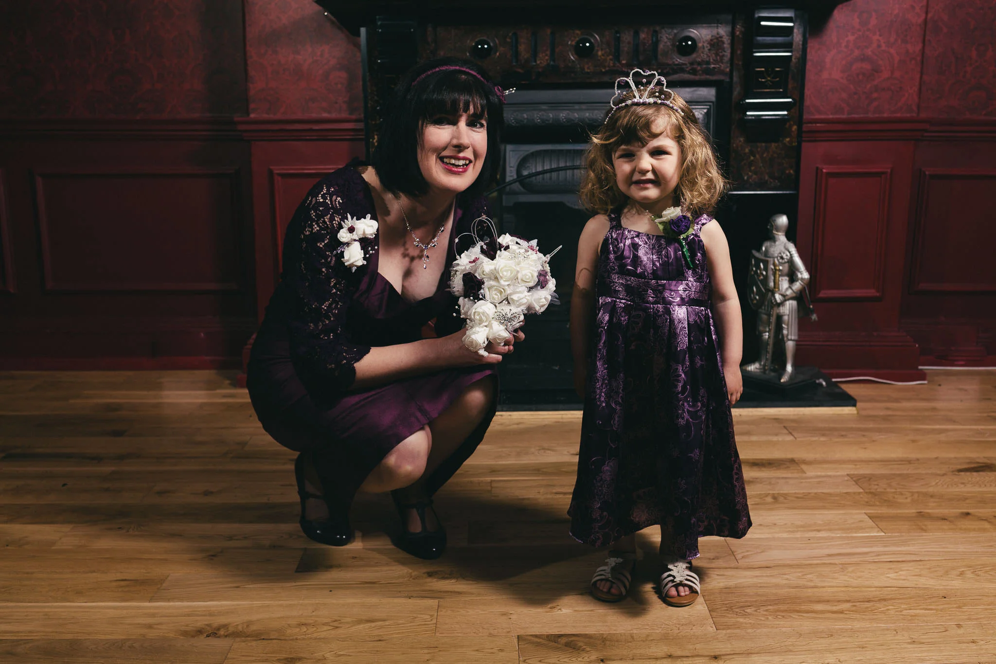 Bride poses with smiling child before her wedding