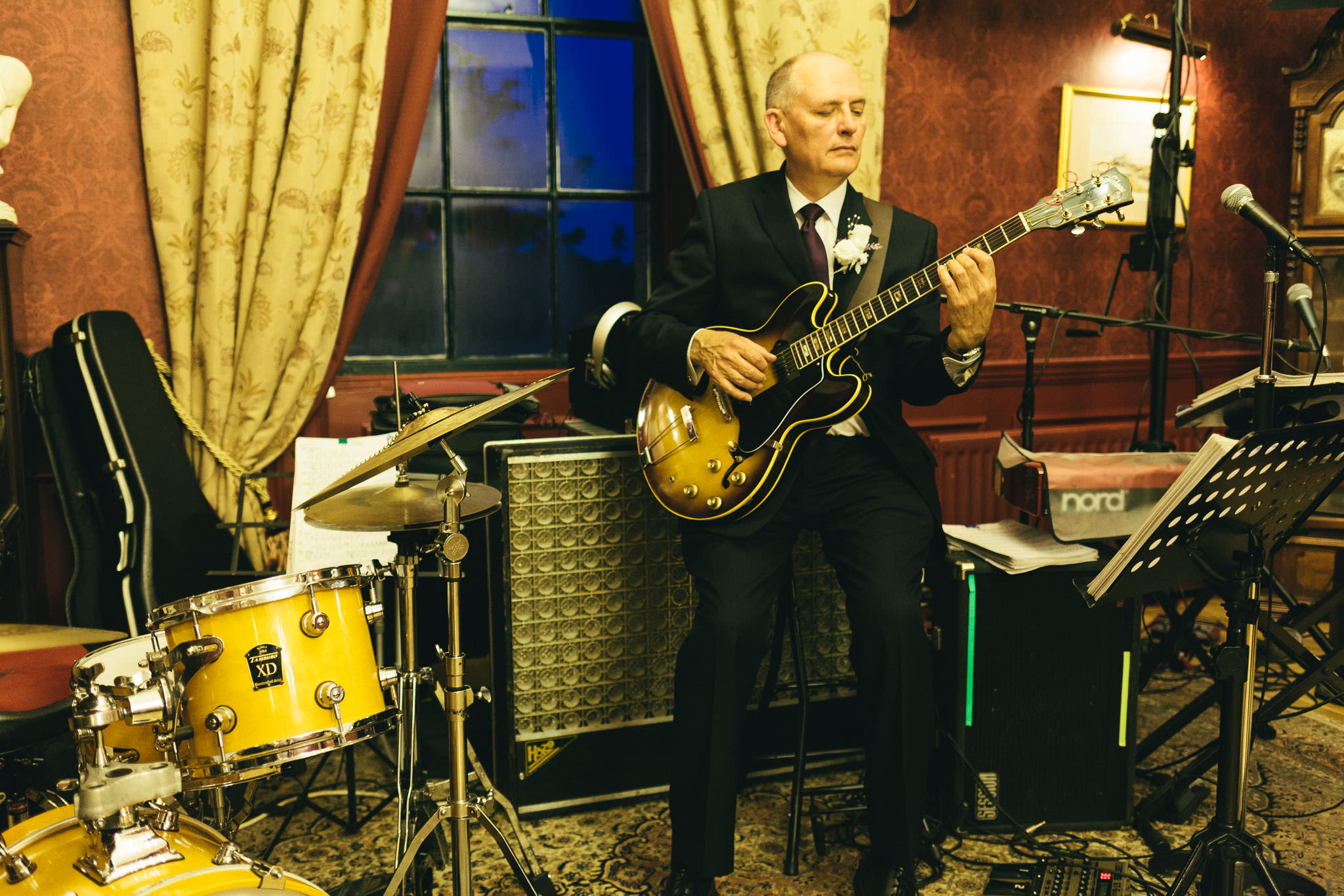 Groom plays guitar at wedding