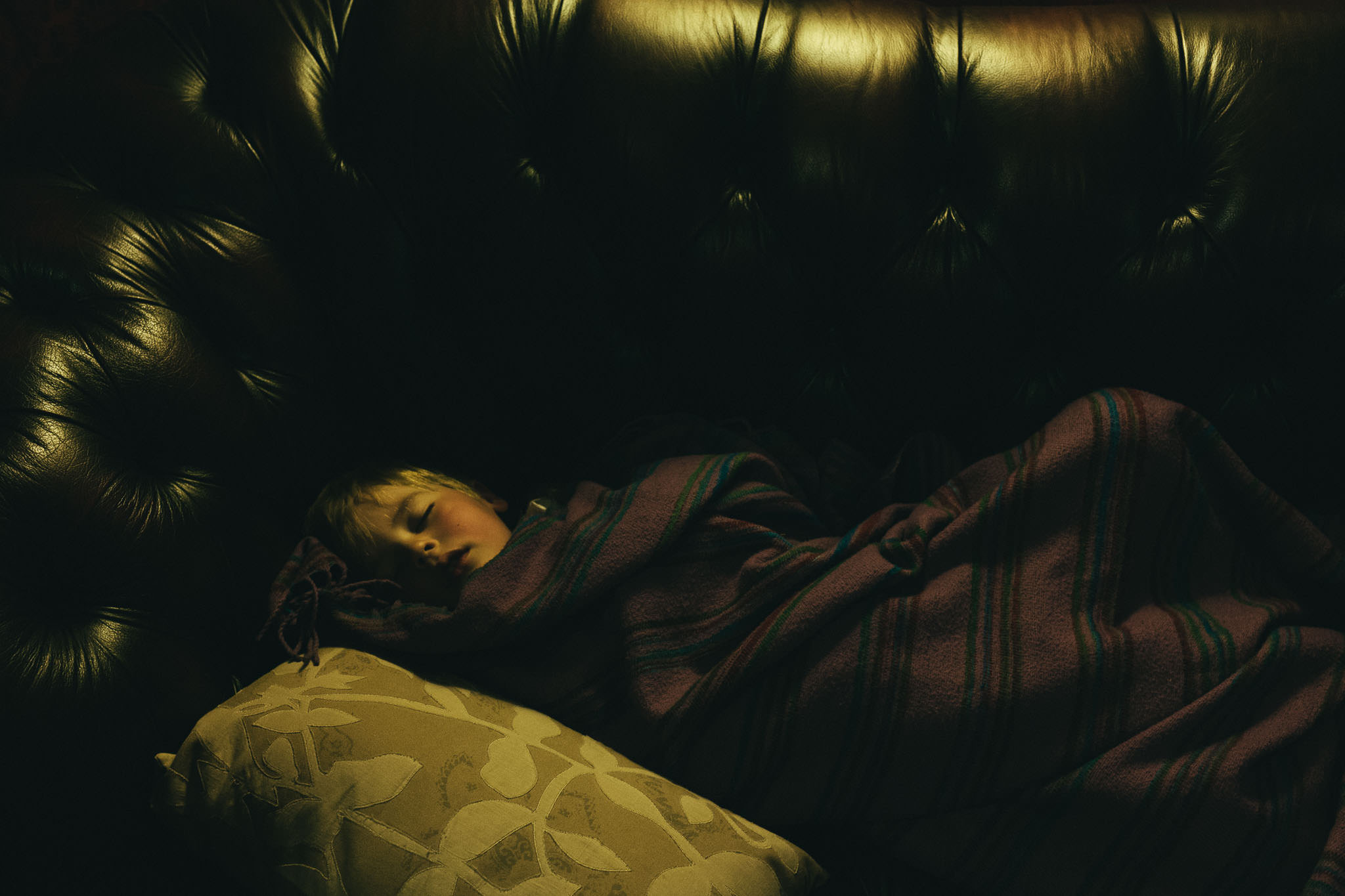 Little boy fast asleep at the end of the wedding night
