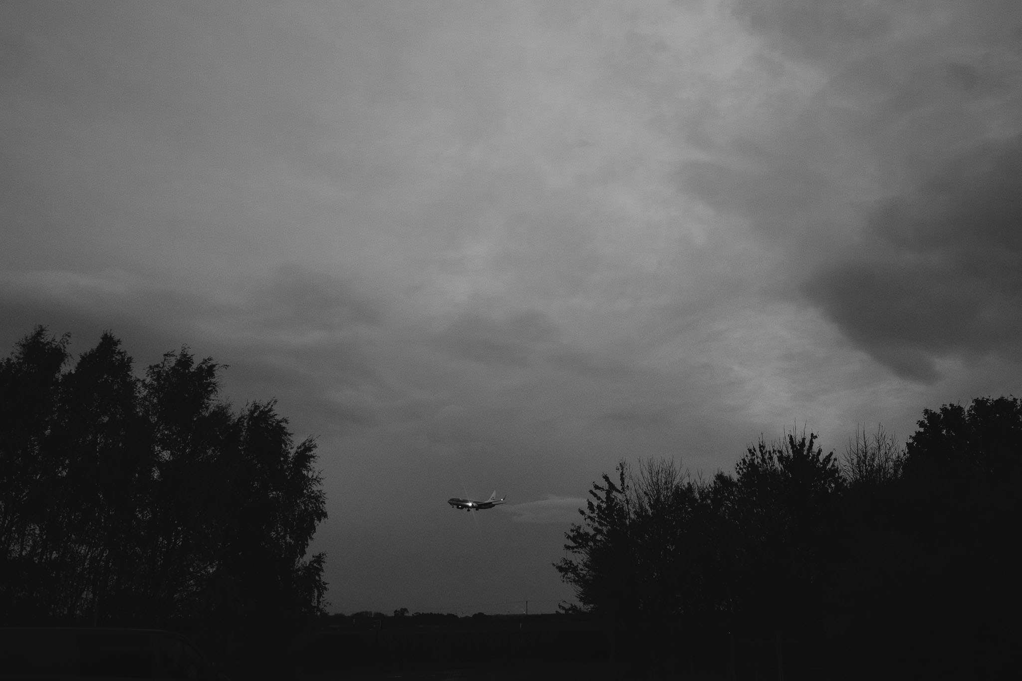 A black and white photograph of a plane landing near Havannah Nature Reserve in Newcastle
