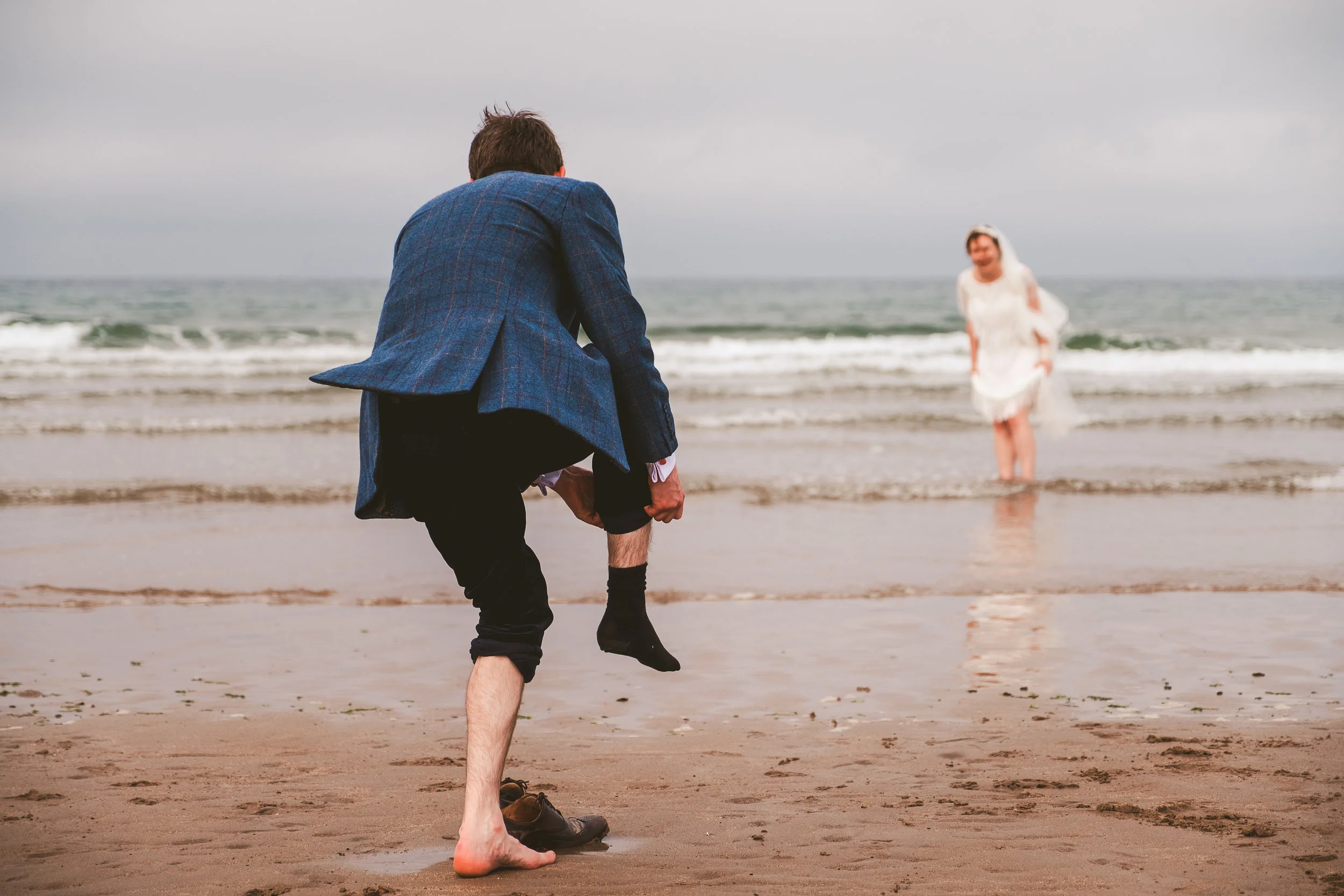 Ellie and James enjoying their wedding day on the Northumberland coast