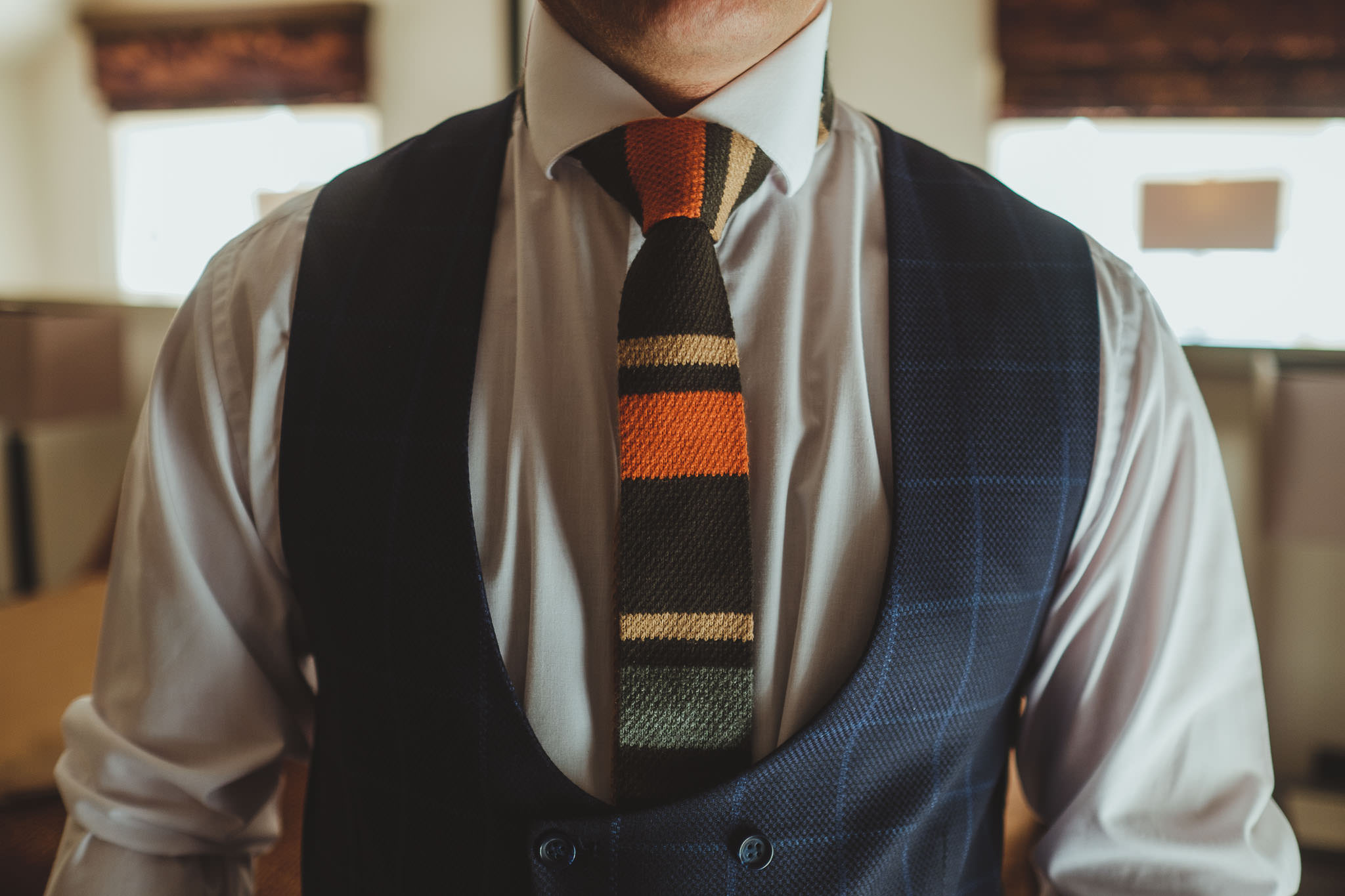 Close up of groom's colourful tie