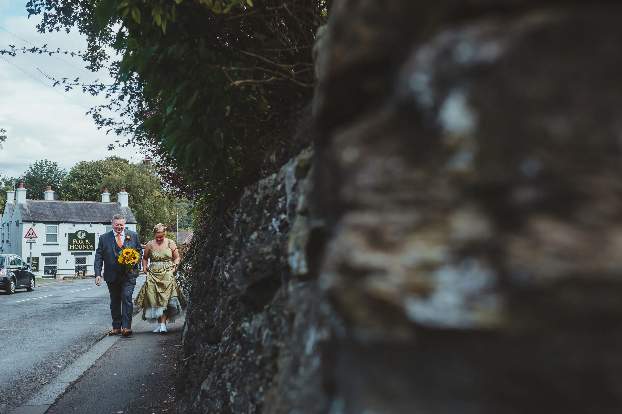 Bride and her father walk through Wylam to the church