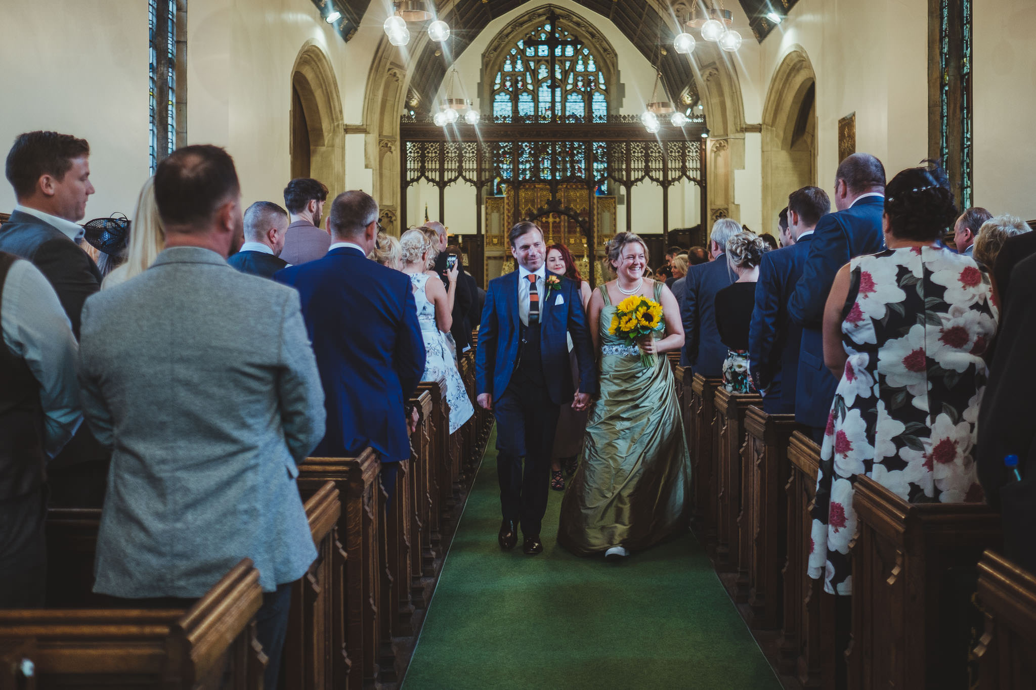 Bride and groom leave the church after their wedding ceremony