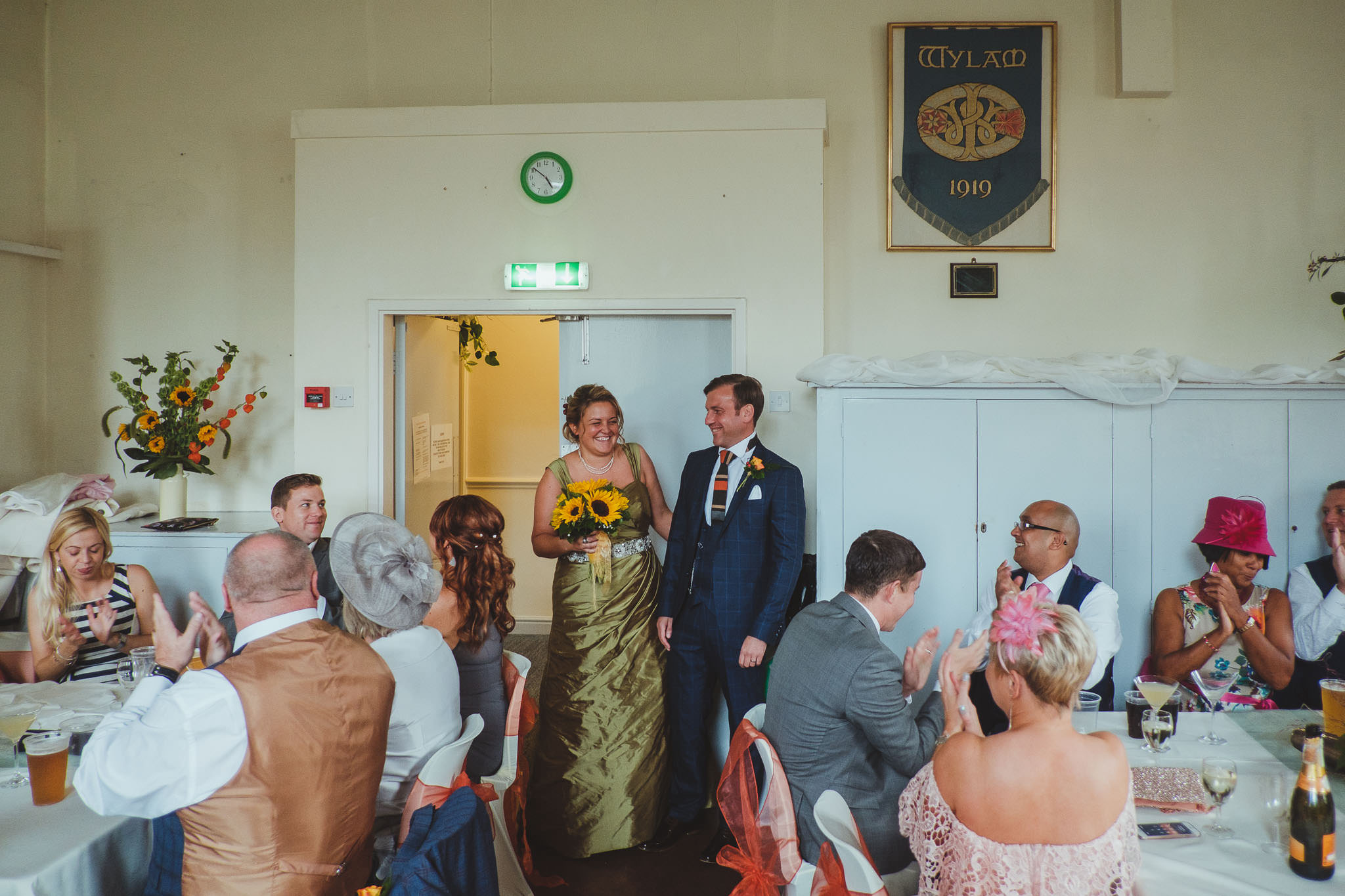 Bride and groom laugh as they enter wedding reception
