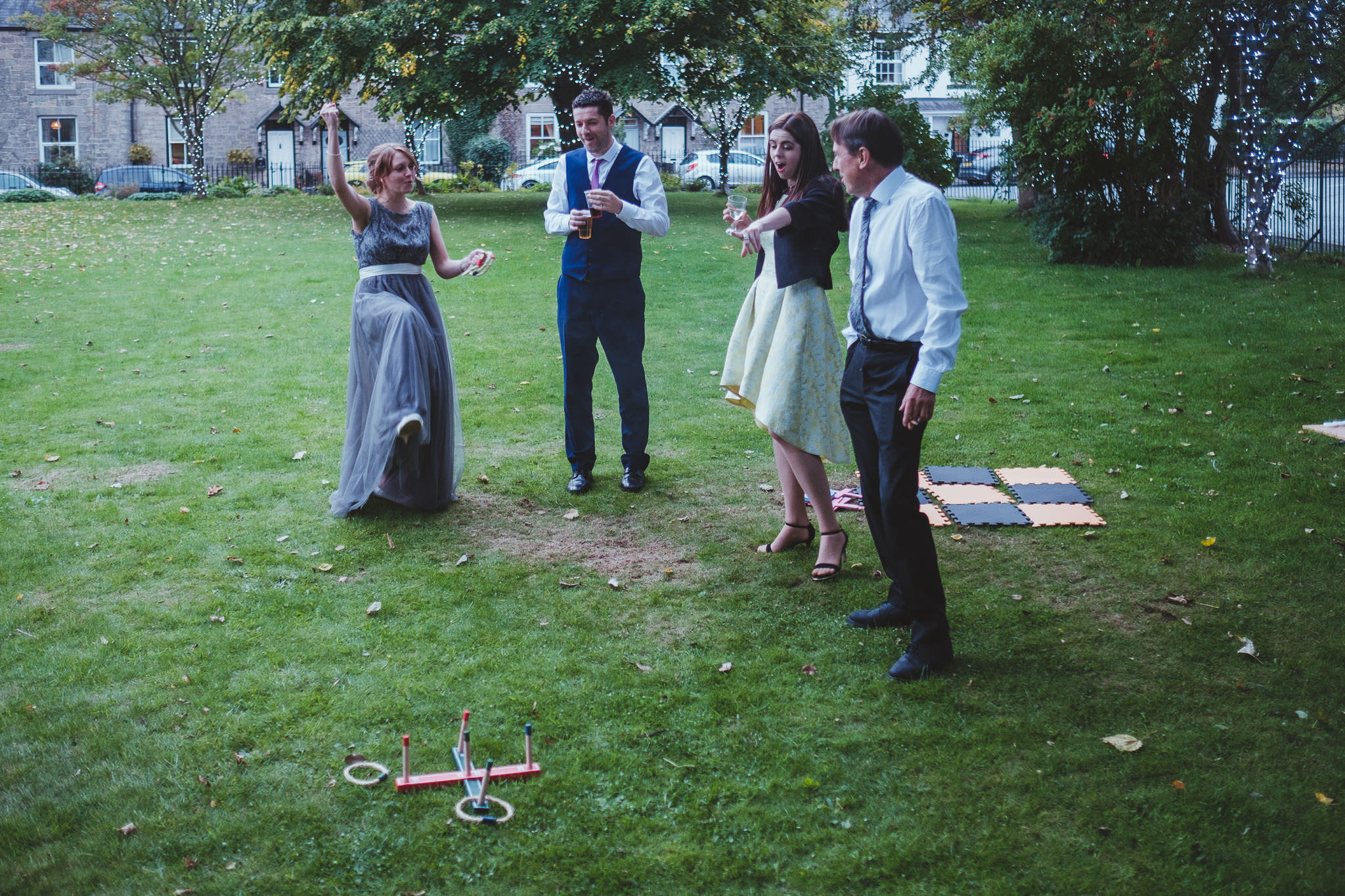 Bridesmaid punches the air as she wins a game of quoits