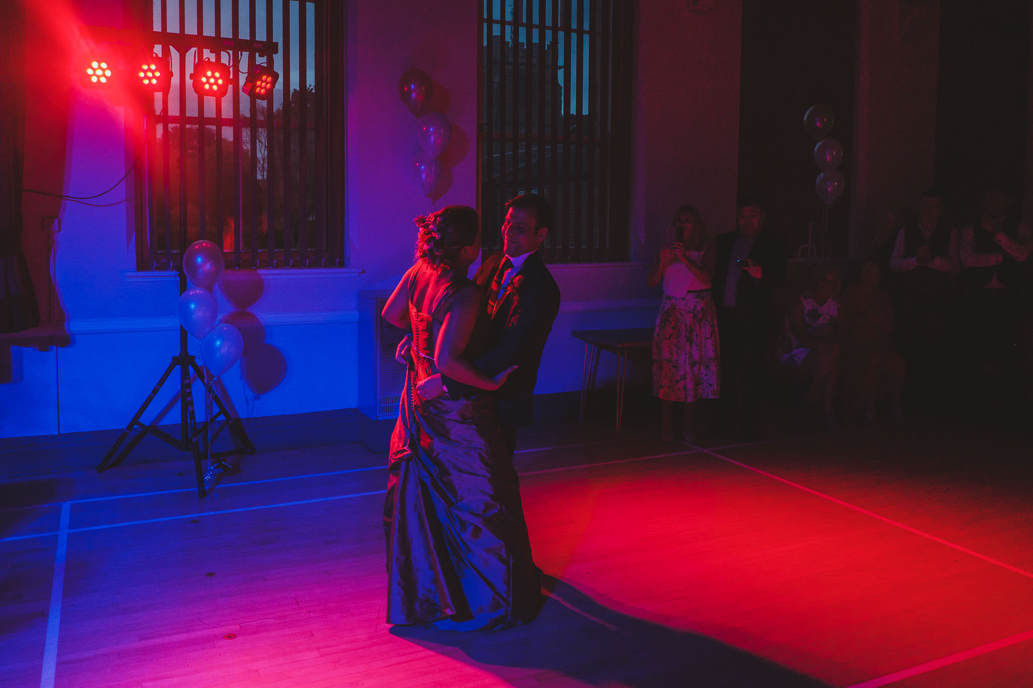 Bride and groom first dance in red and blue light