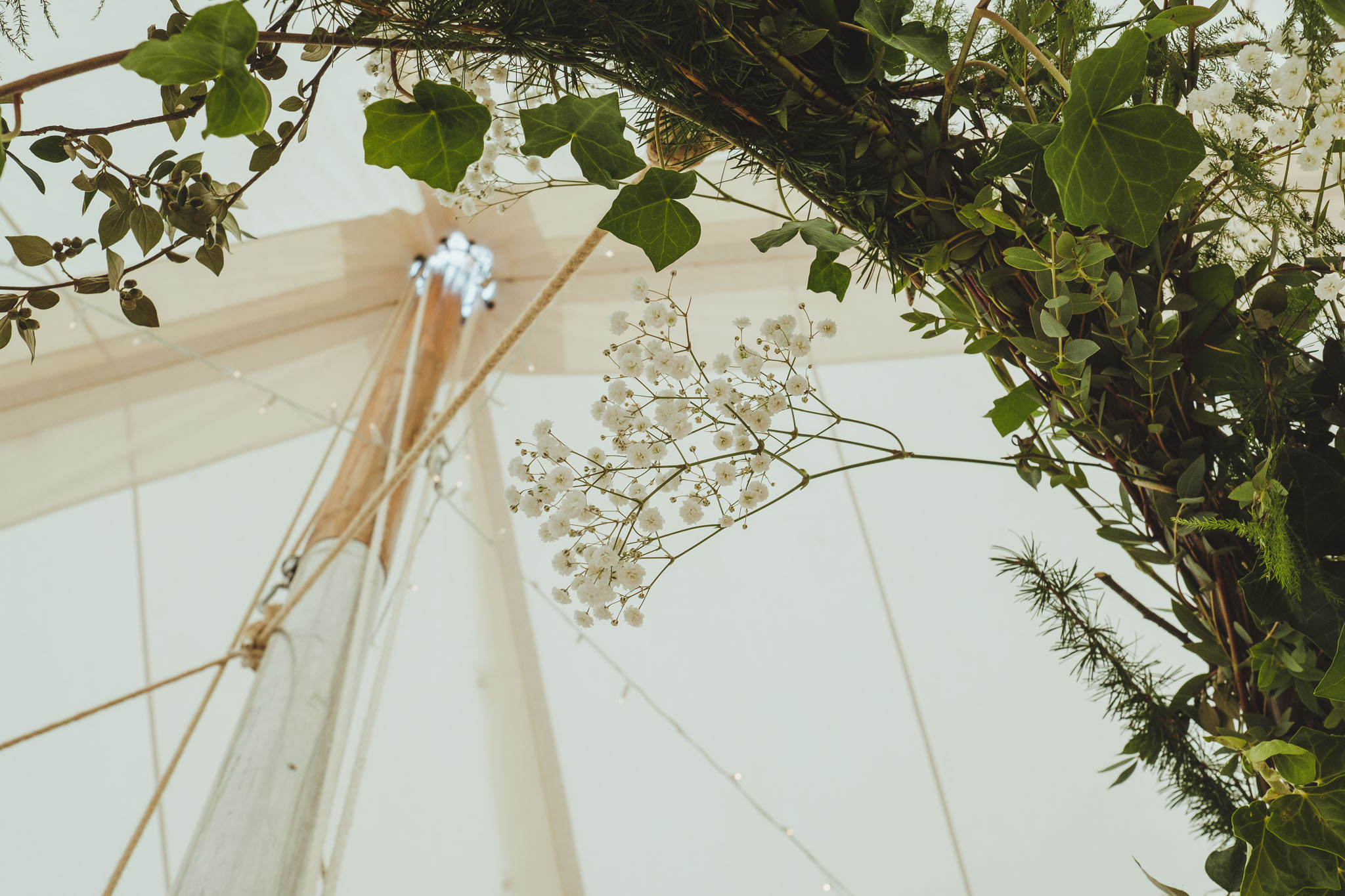 Close up of decorative foliage inside the wedding marquee