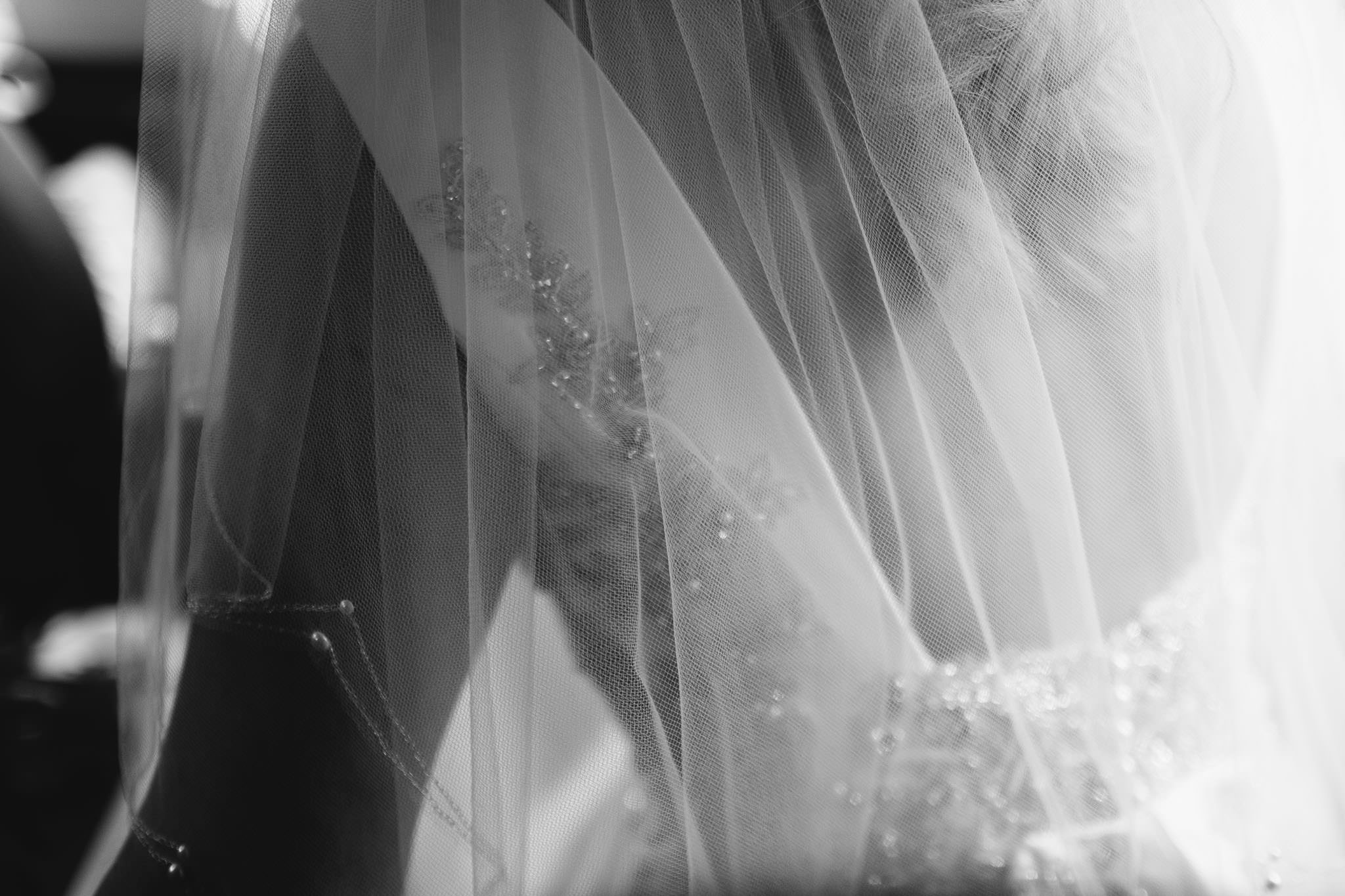 A black and white close up photo of the bride's wedding dress