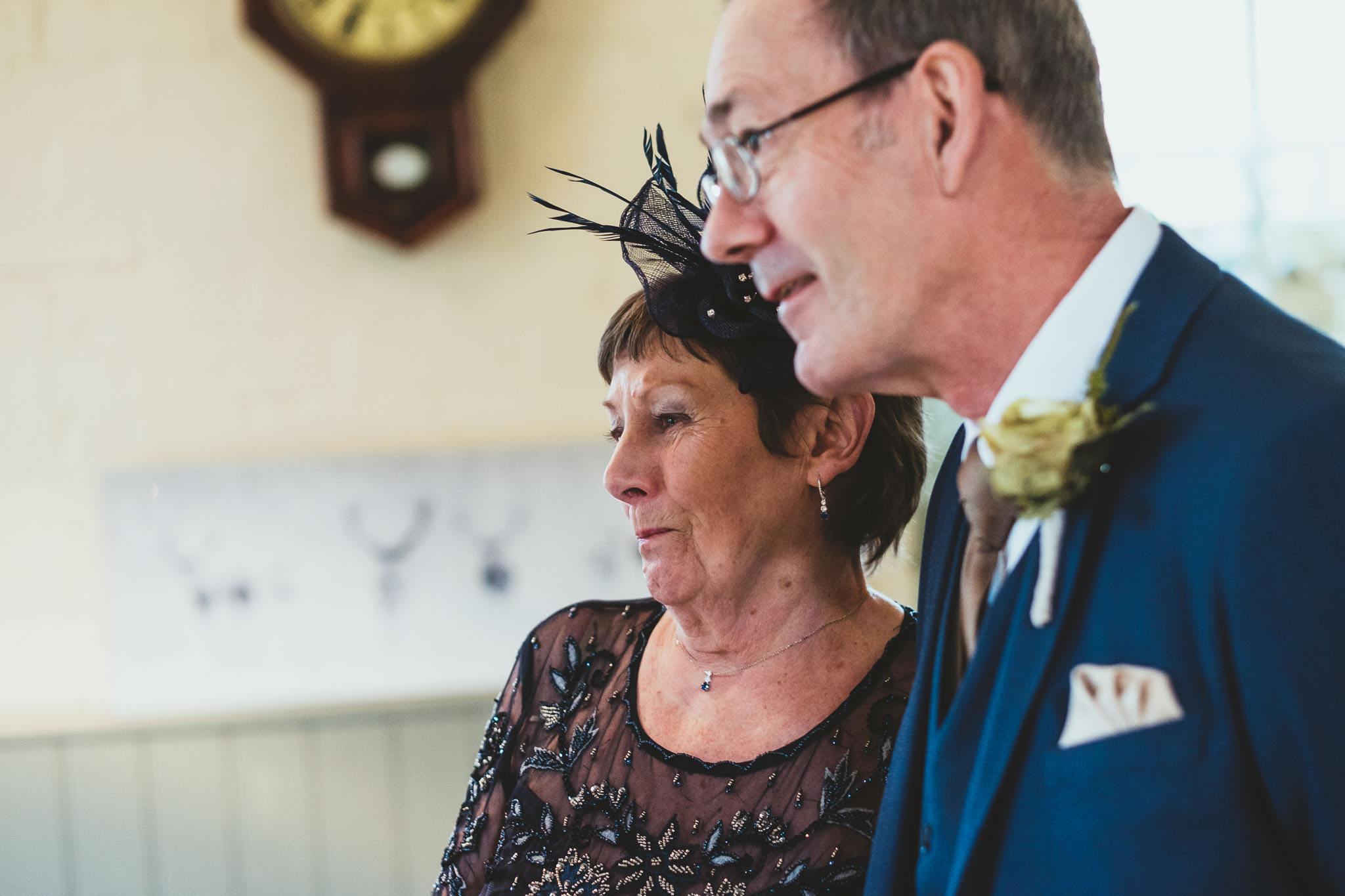 Bride's mother and father look on lovingly before wedding ceremony