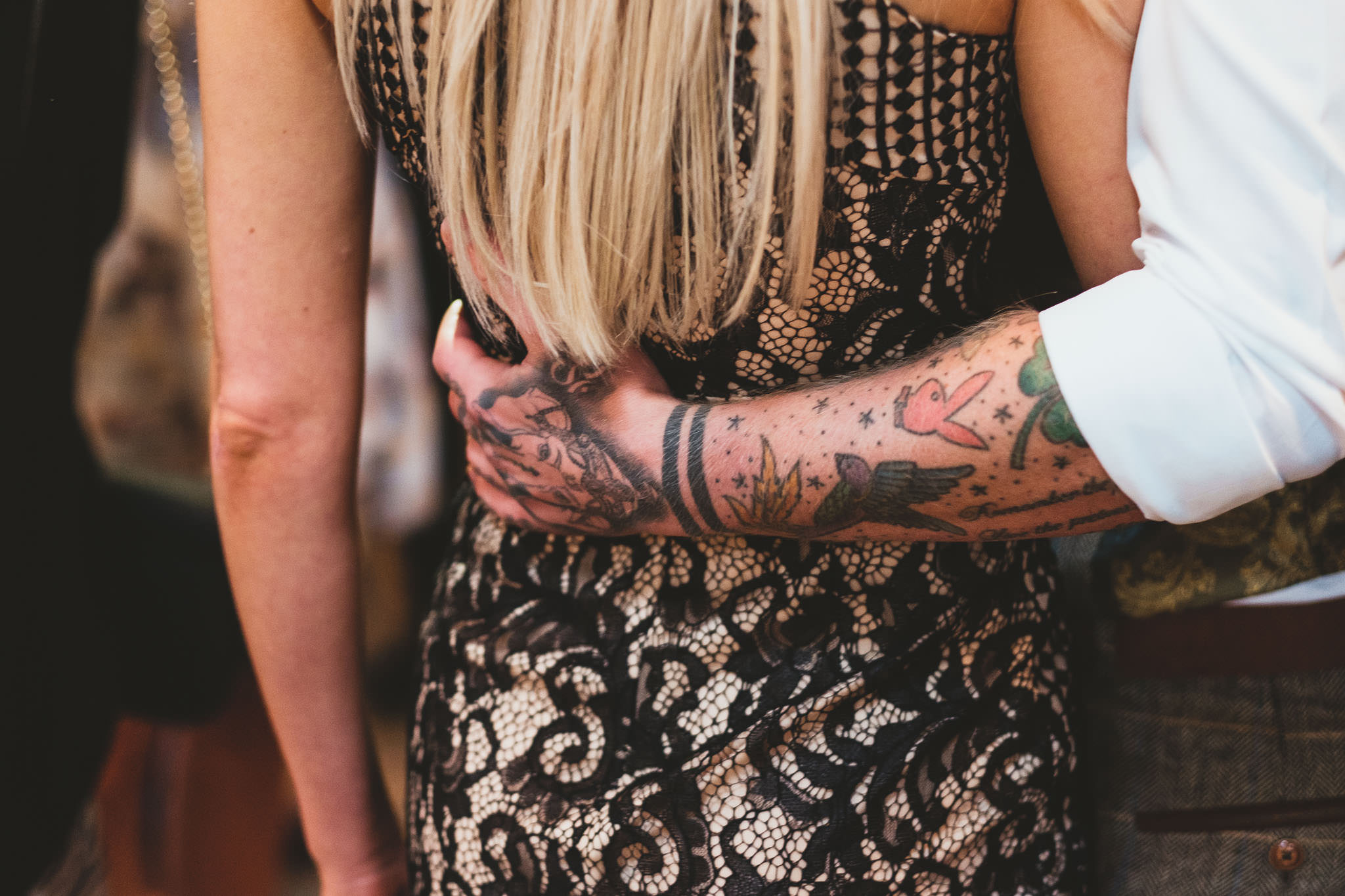 Close up of guest's tattooed arm during wedding reception