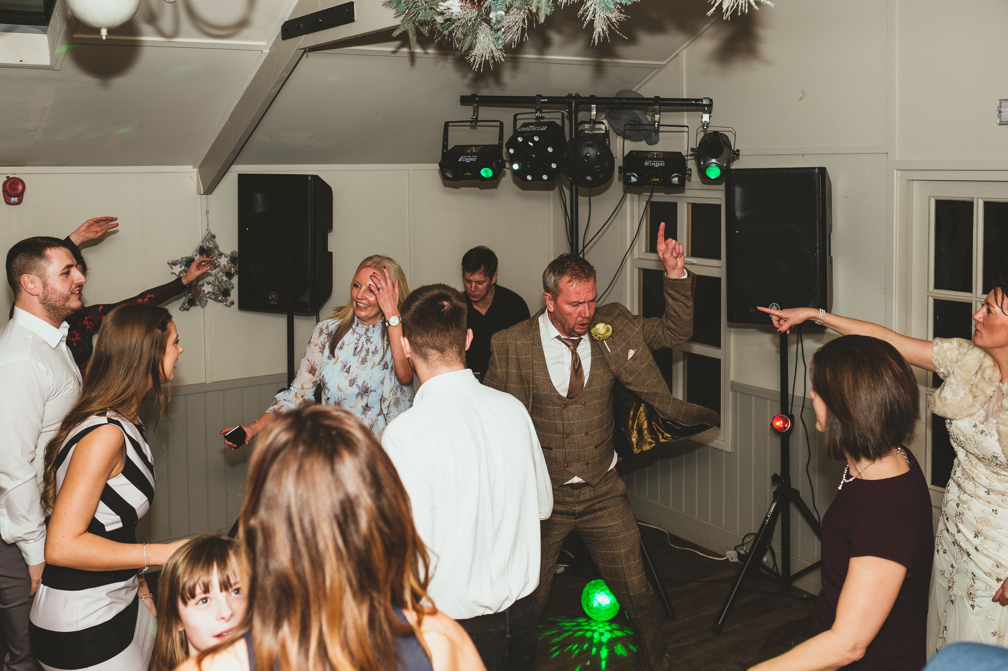 Bride and groom point at each other on wedding dance floor