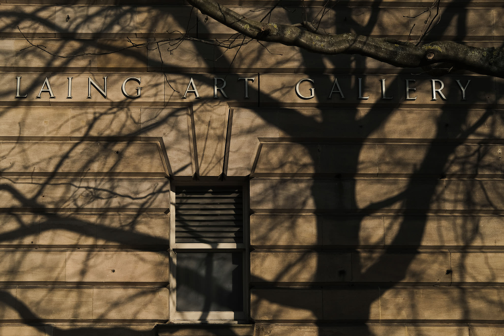 Laing Art Gallery sign covered in tree shadow