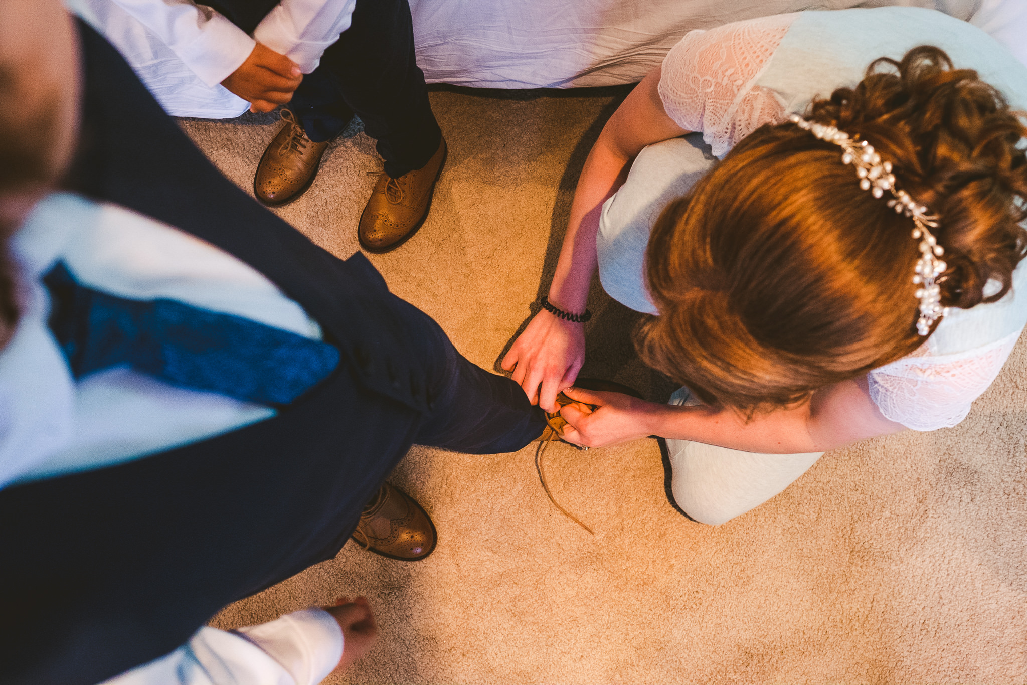 Bride tying her son's shoelace