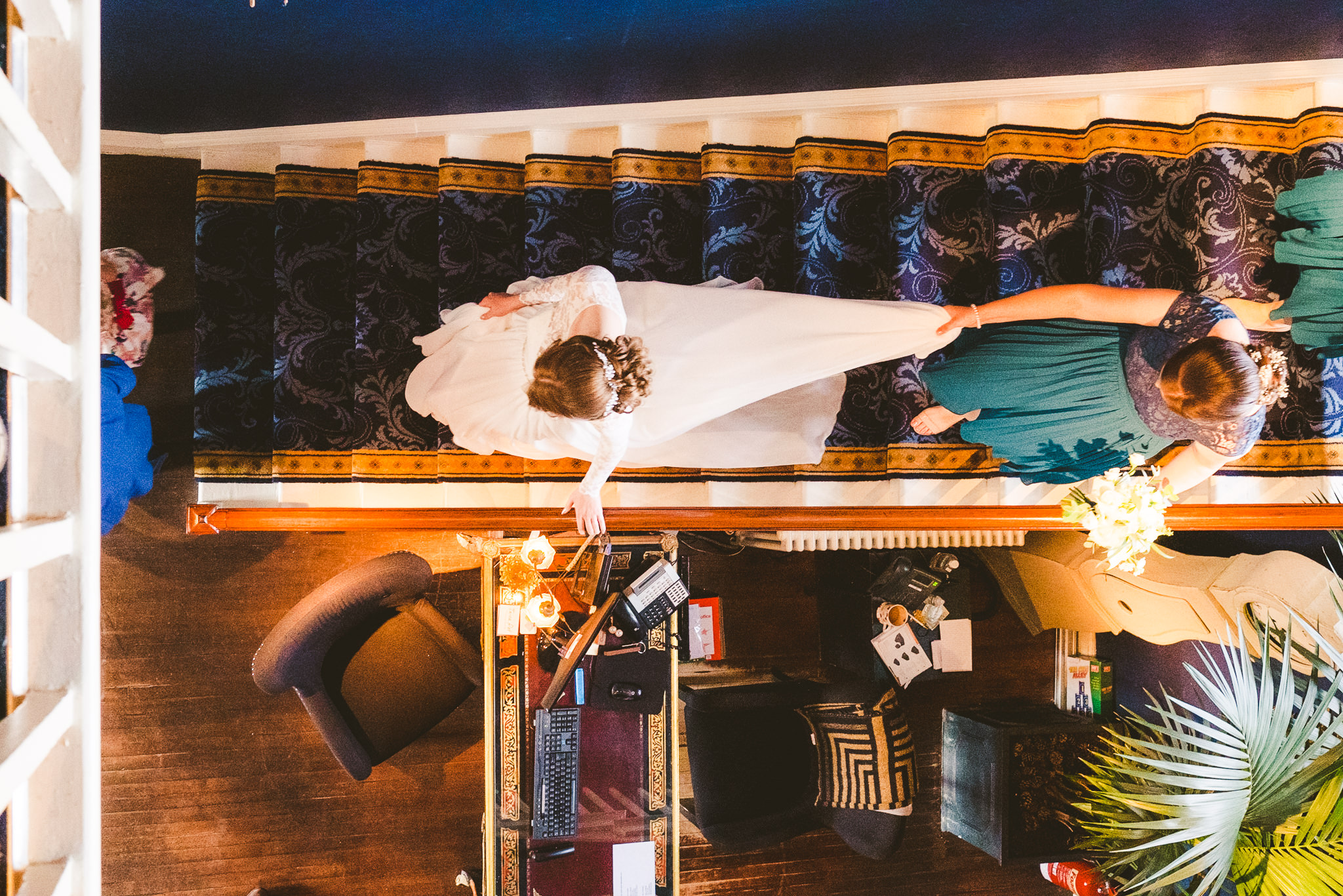 Overhead view of the bride walking down the stairs at Newton Hall