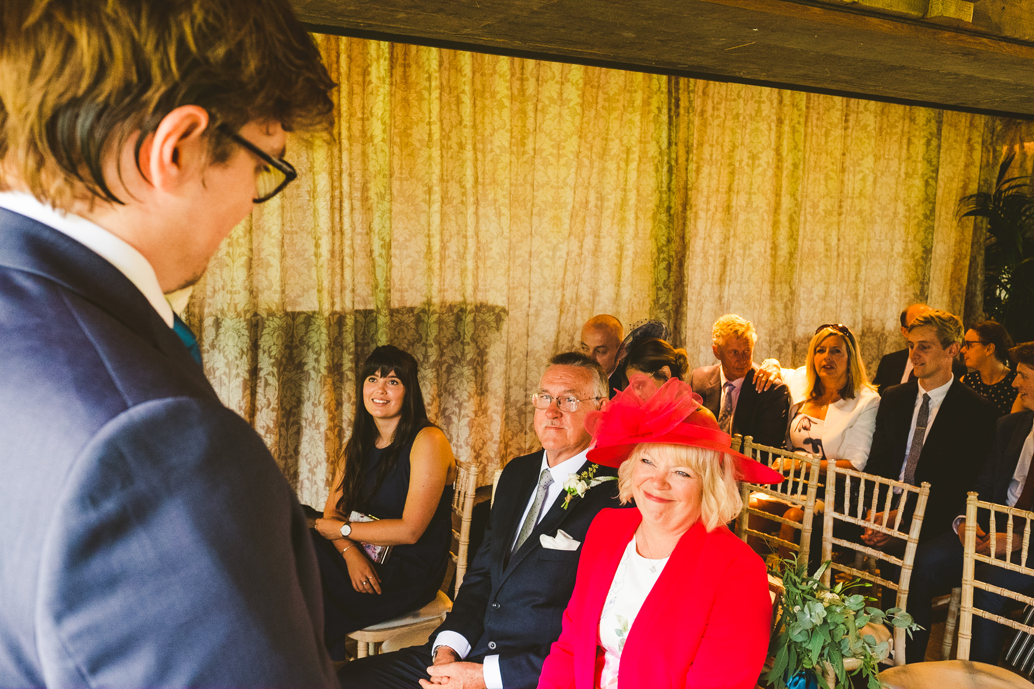 Mother of the groom smiles at her son before the ceremony
