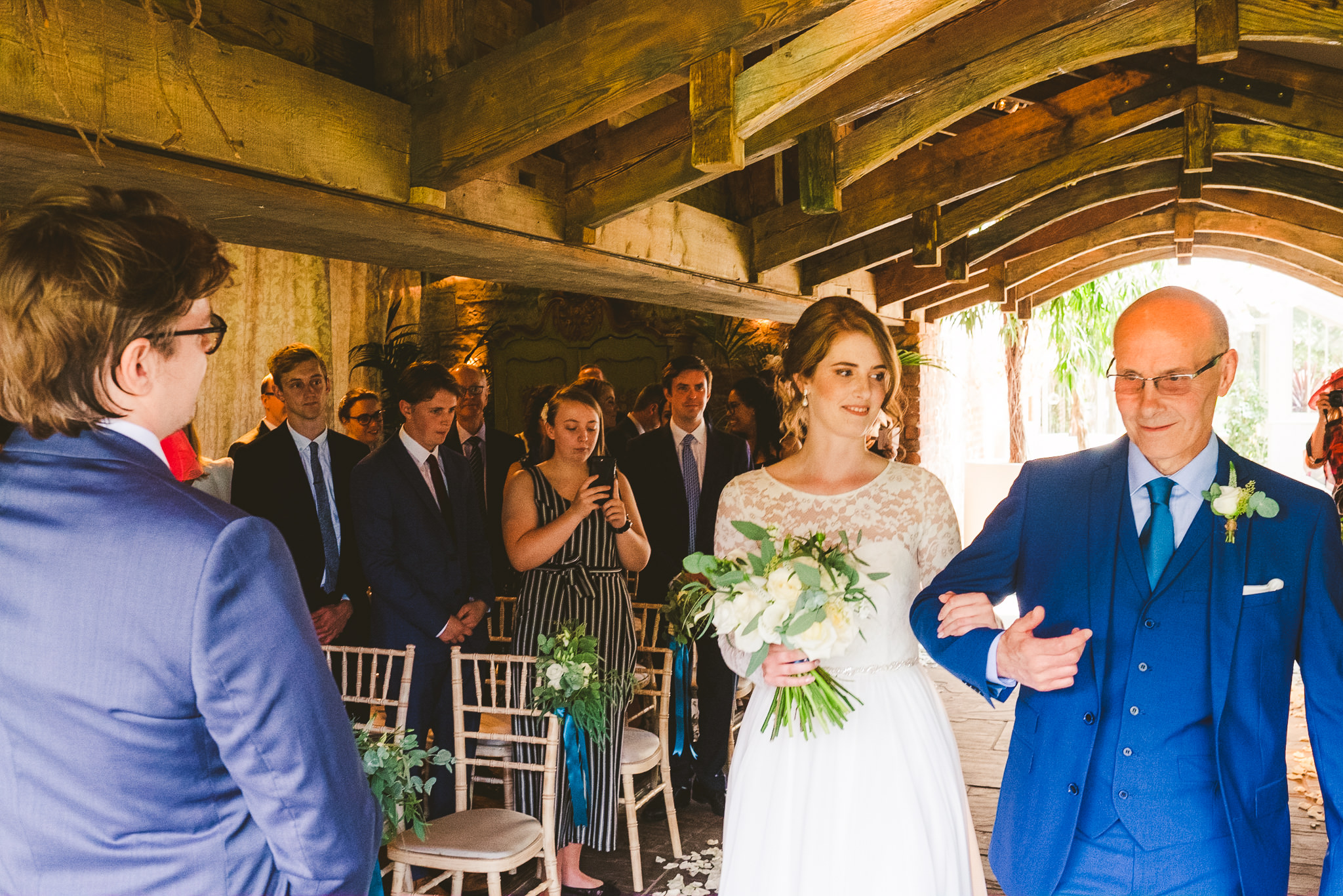 Bides, her father and the groom meet at the end of the aisle at Newton Hall