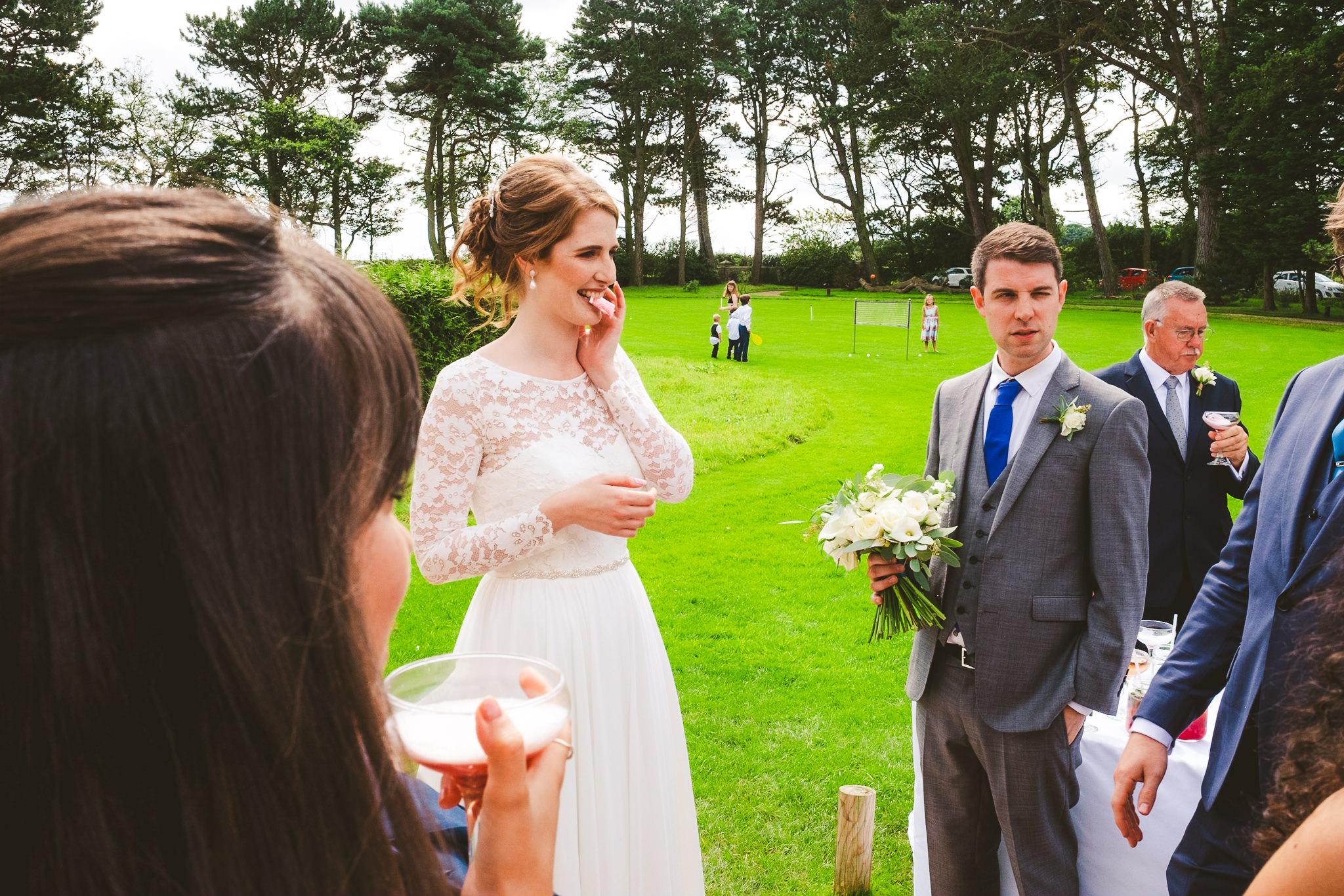 A magician entertains the bride and groom outside at Newton Hall