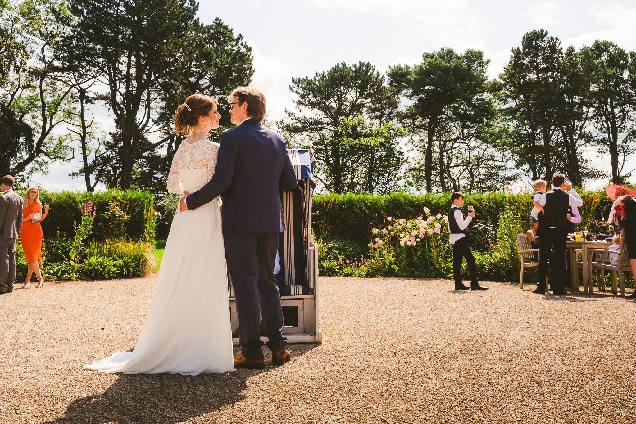 The bride and groom cuddle in the courtyard of Newton Hall