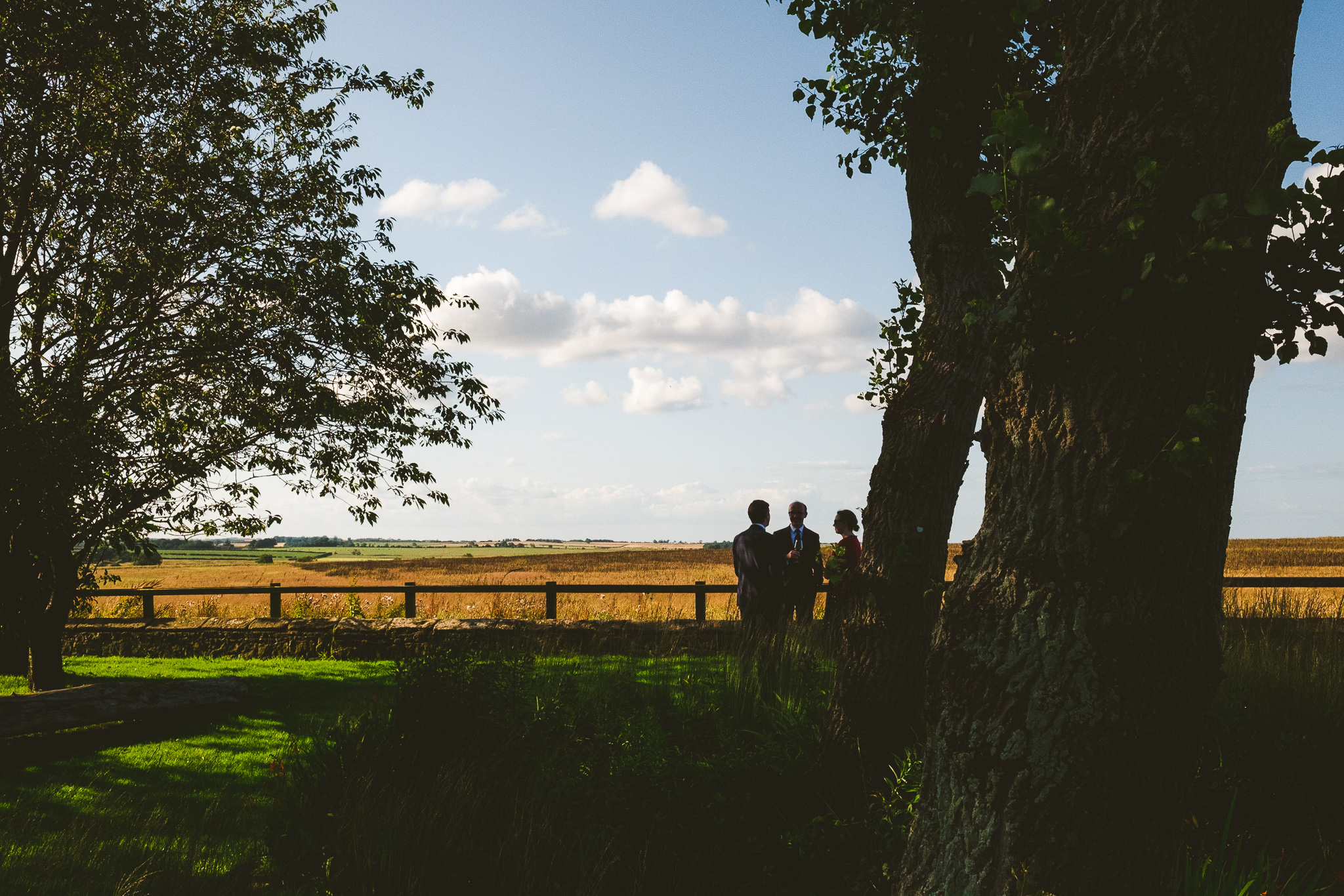Wedding guests silhouetted against the sky at Newton Hall