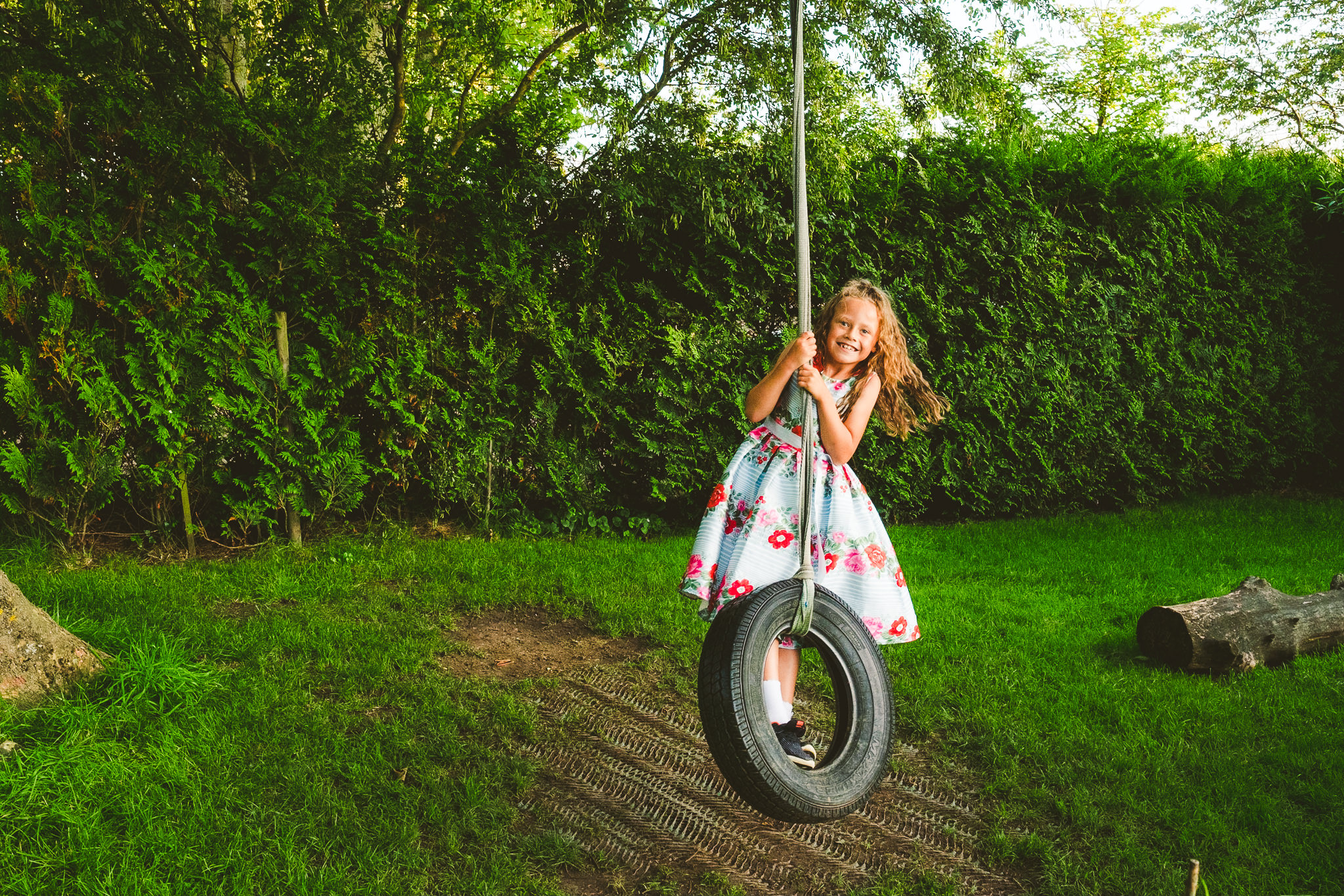 Girl swings on rope swing at Newton Hall