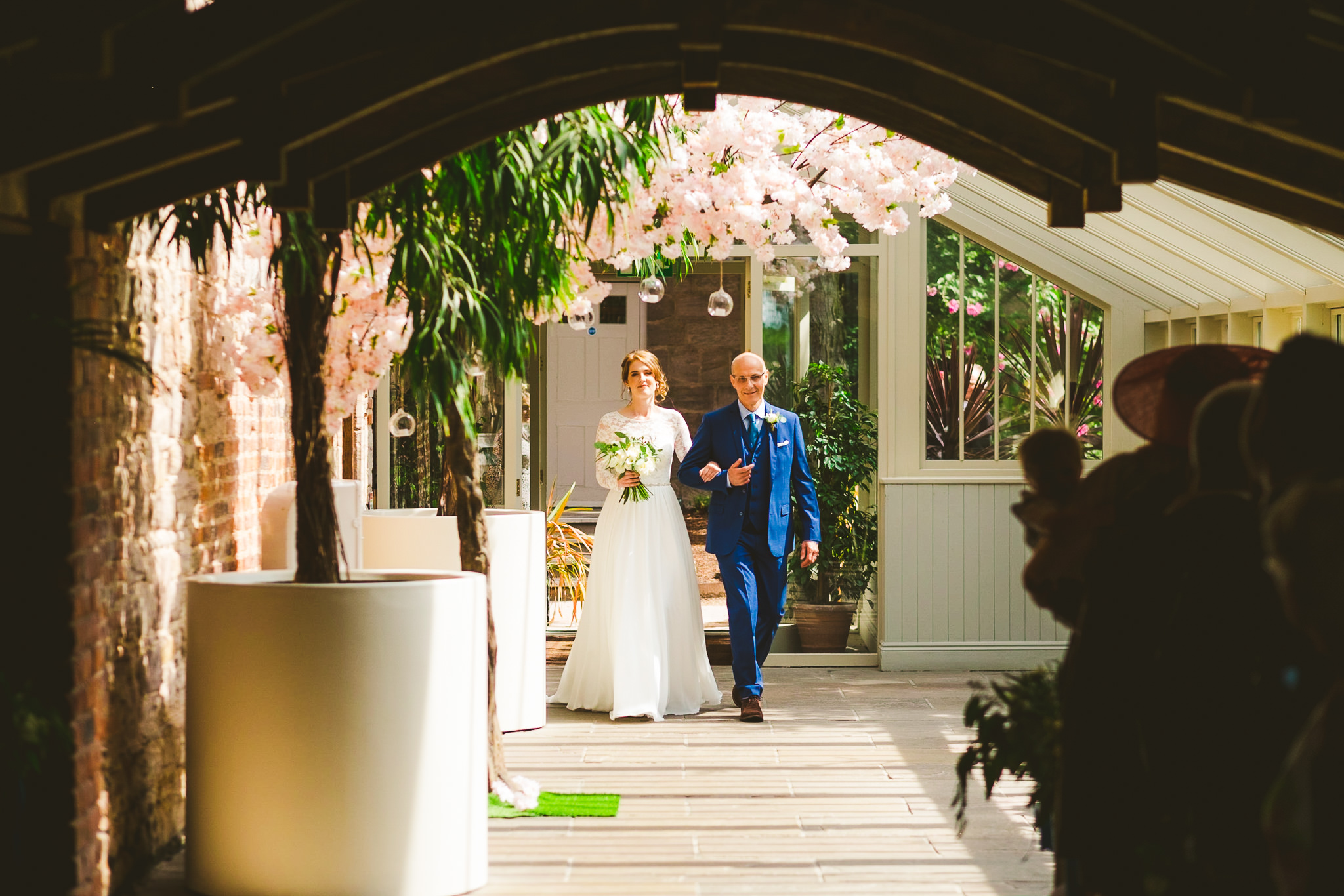 Bride walking down the aisle in her dad's arms at Newton Hall