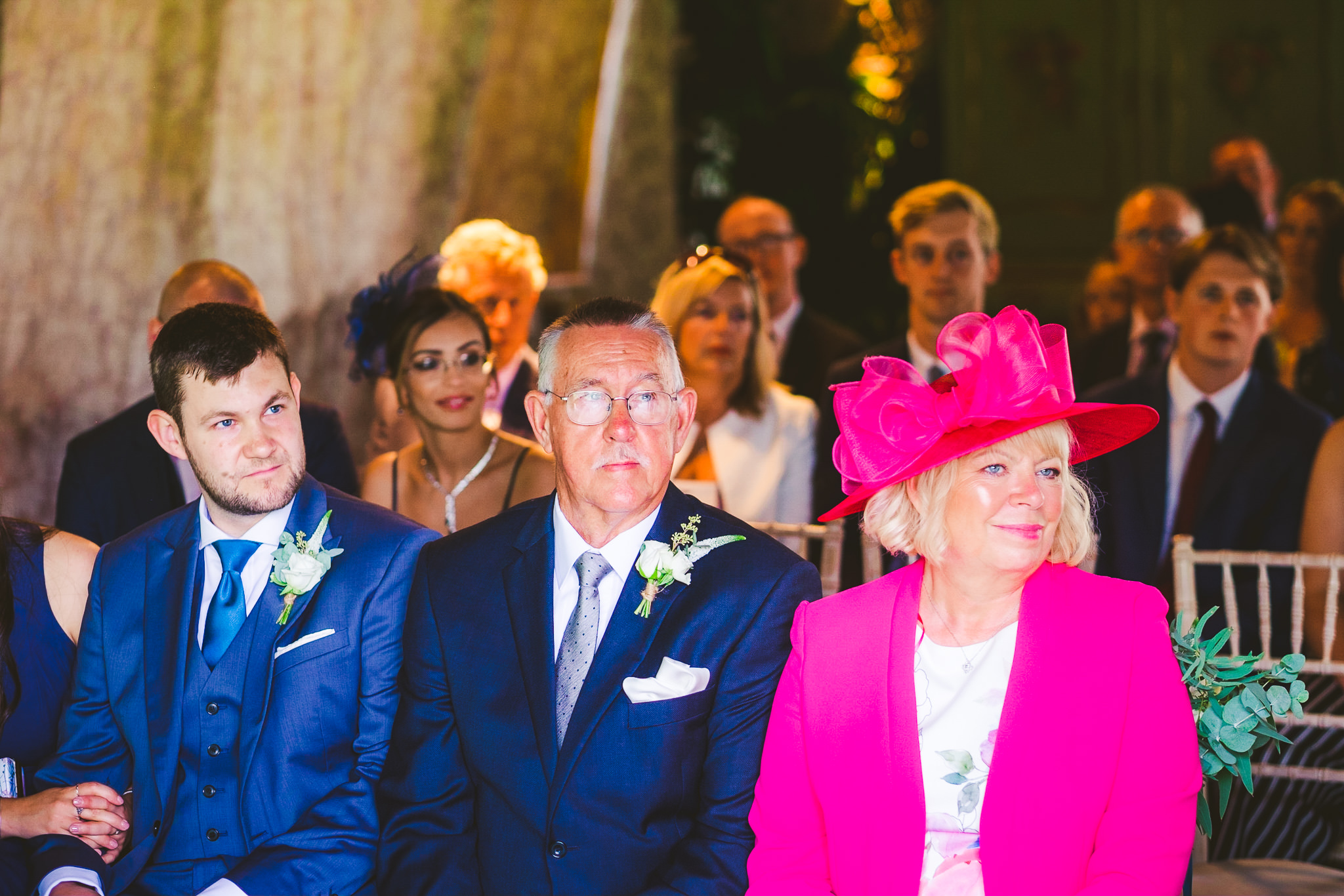 The groom's family look on during the wedding ceremony