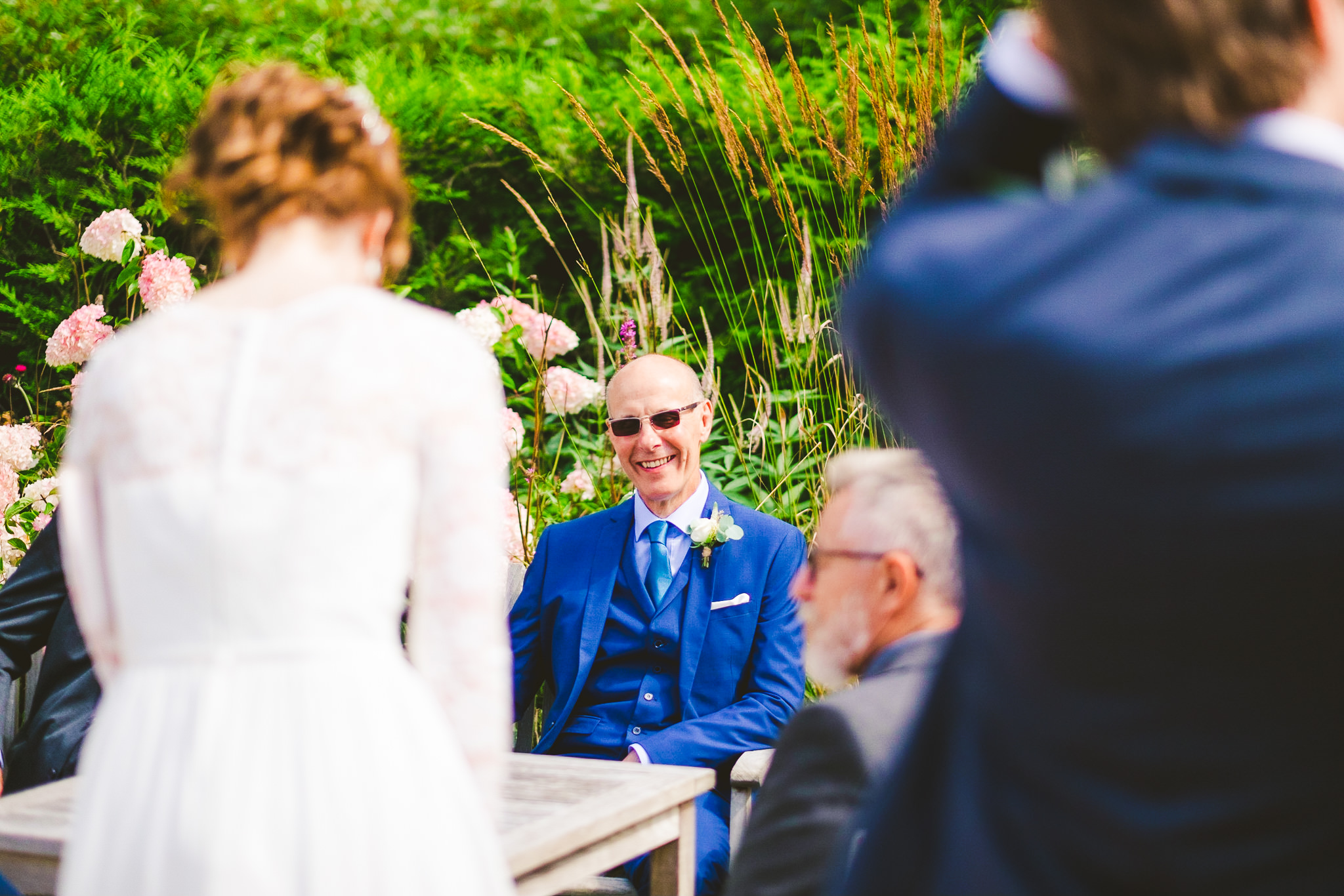 The father of the bride laughs at the bride's joke
