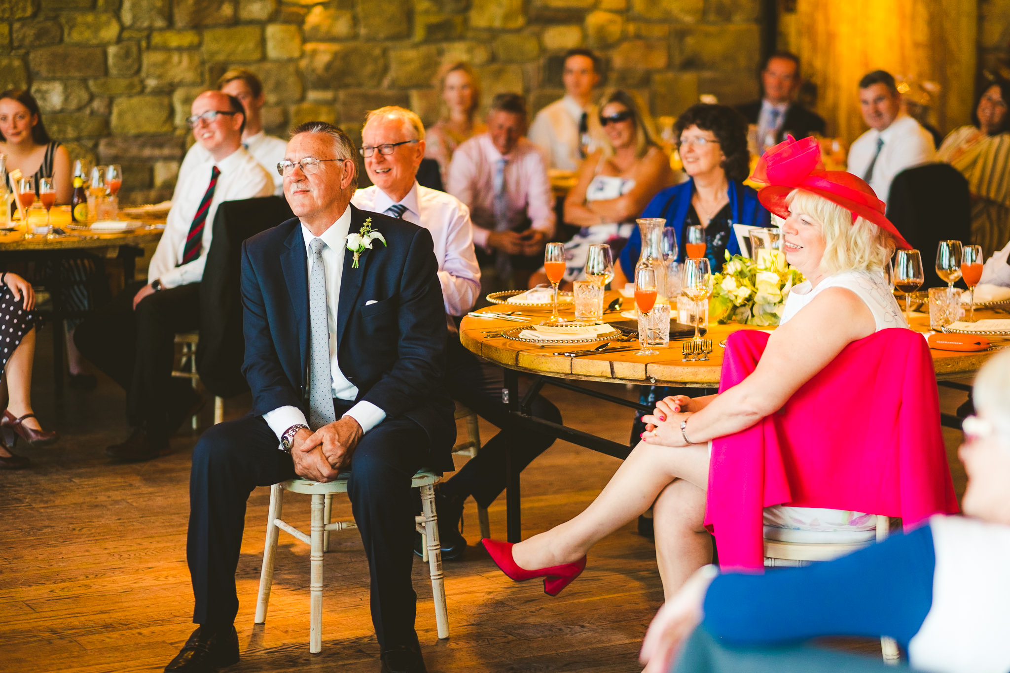 Father and mother of the bride watch wedding speech