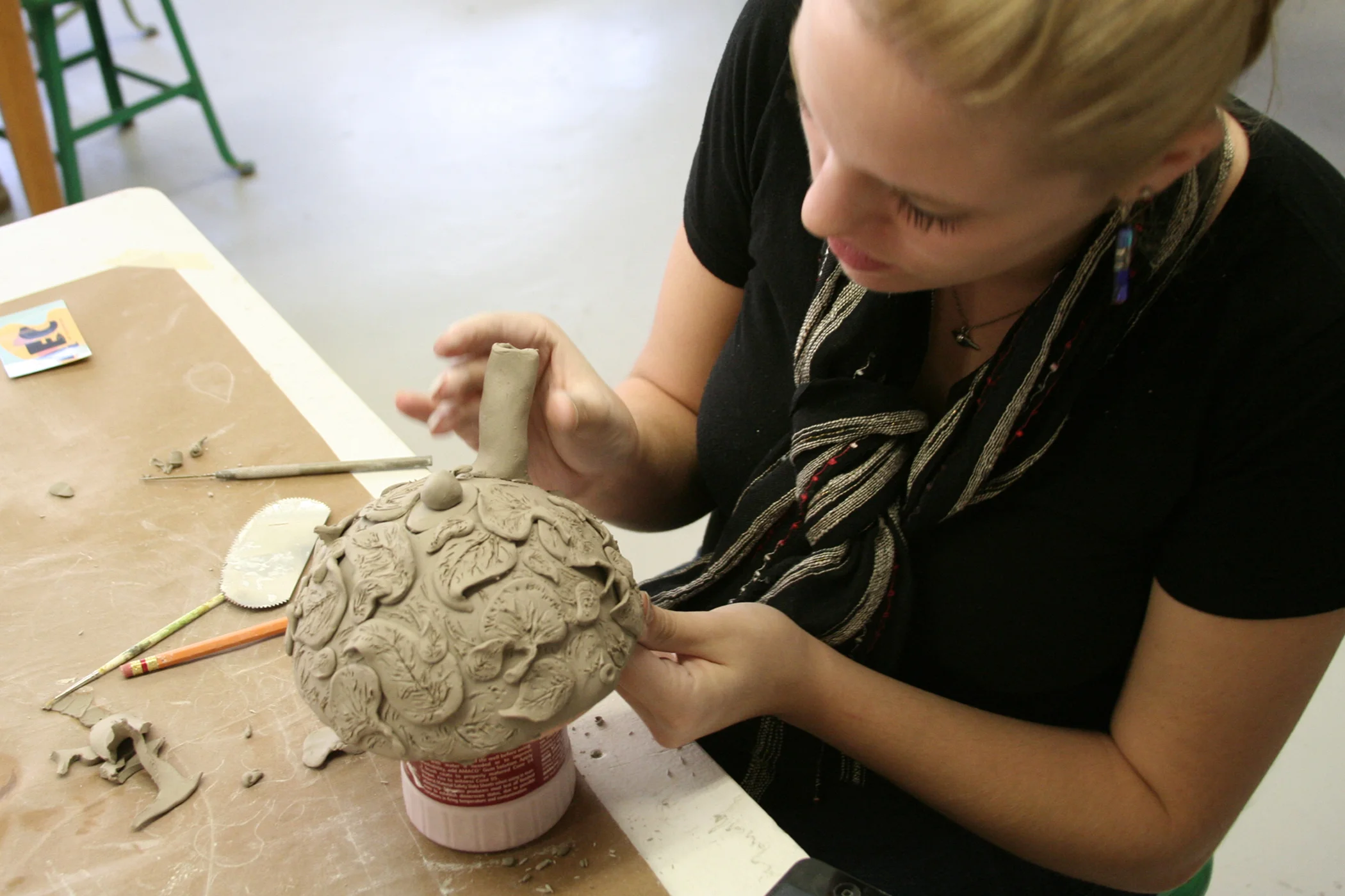 A student is attaching the spout to the body
