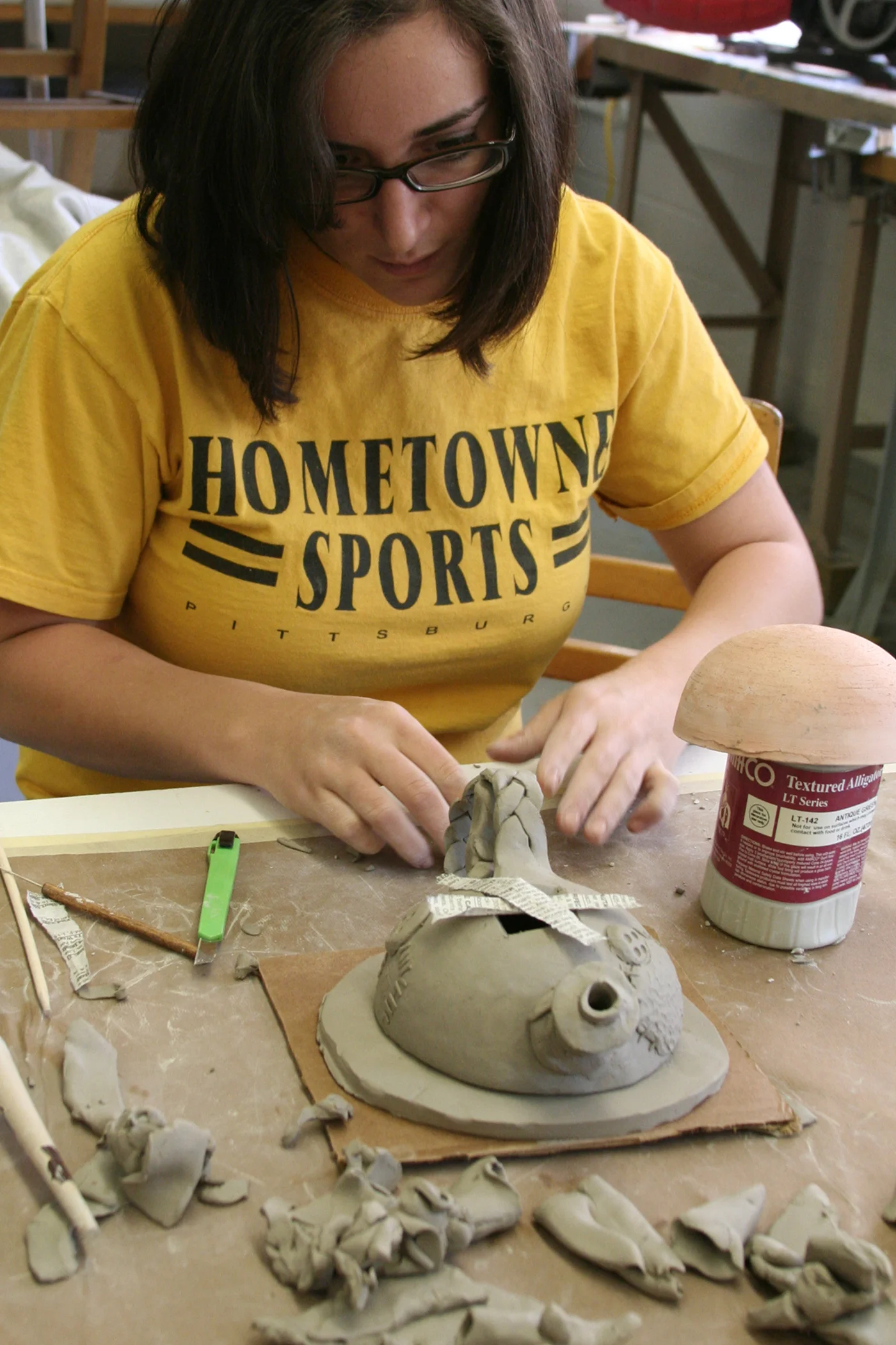 A student is attaching the handle and the bottom