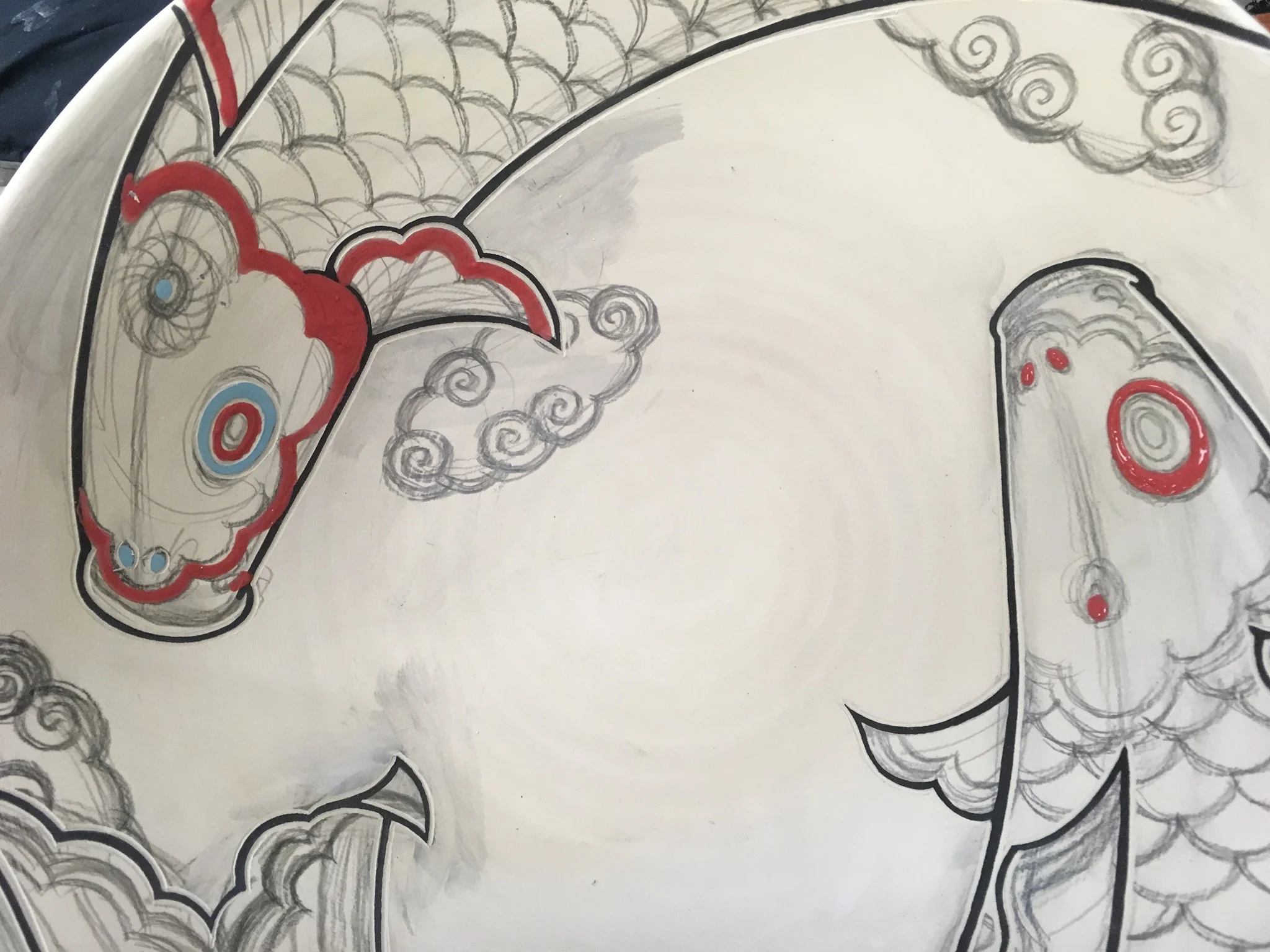 Start applying some colors for the details. You can see how the black underglaze lines are cleaned up.