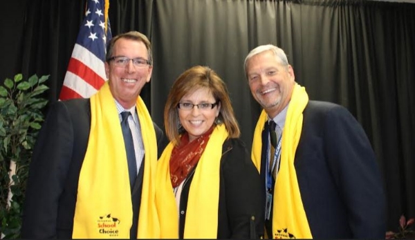 A picture in the Yellow Scarves with Principal, Lis Richard and Director, Don Griffin. 