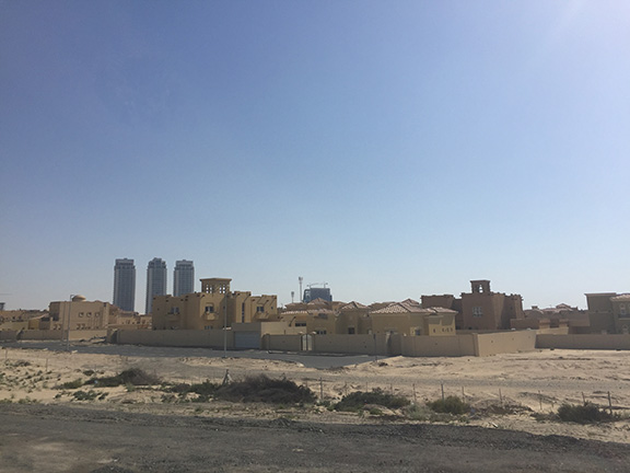 Driving out to Global Market, which lies on the edge of Dubai, we passed many neighbourhood filled with desert mansions (©Deborah Clague, 2016).&nbsp;