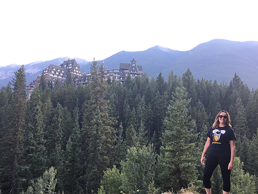 Hiking near Bow Falls with the iconic Banff Springs Hotel in the background.