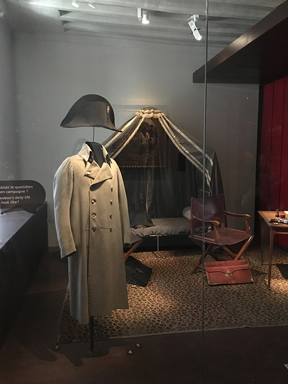 Napoleon’s campaign clothing and furniture, including the cot where he slept, Les Invalides (©Deborah Clague, 2019).