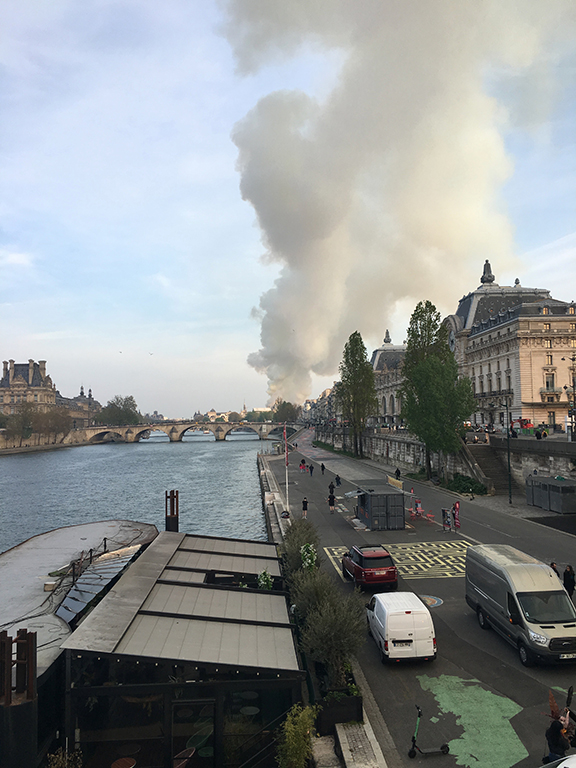 View of Notre-Dame Cathedral fire from Passerelle Léopold-Sédar-Senghor, Paris (©Deborah Clague, 2019).