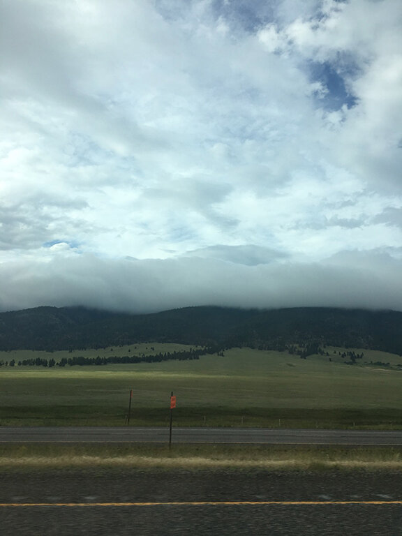 Clouds cover the mountains in Montana (we’d soon be driving through them)(©Deborah Clague, 2019).