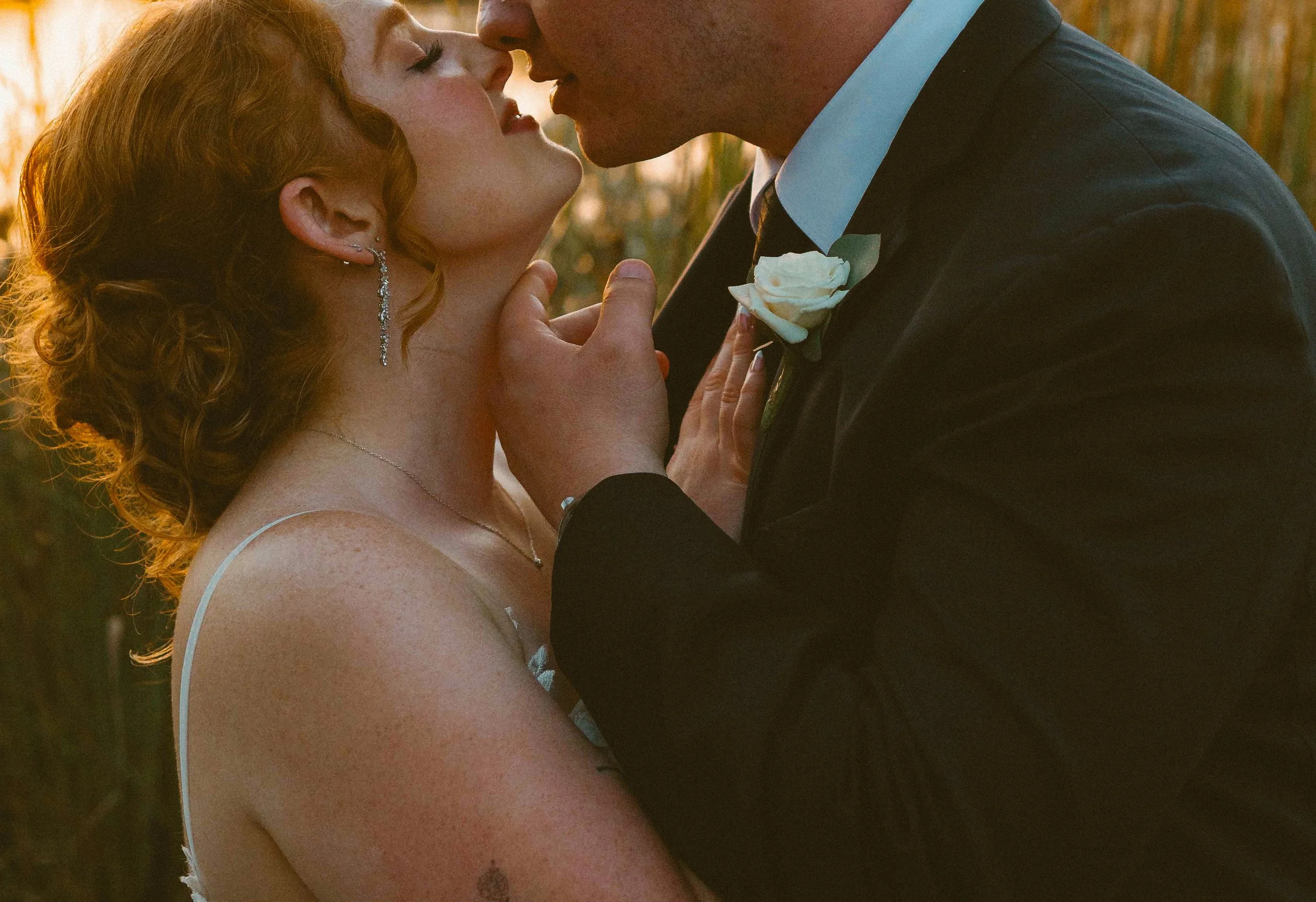 Bride and Groom at sunset in a candid kiss