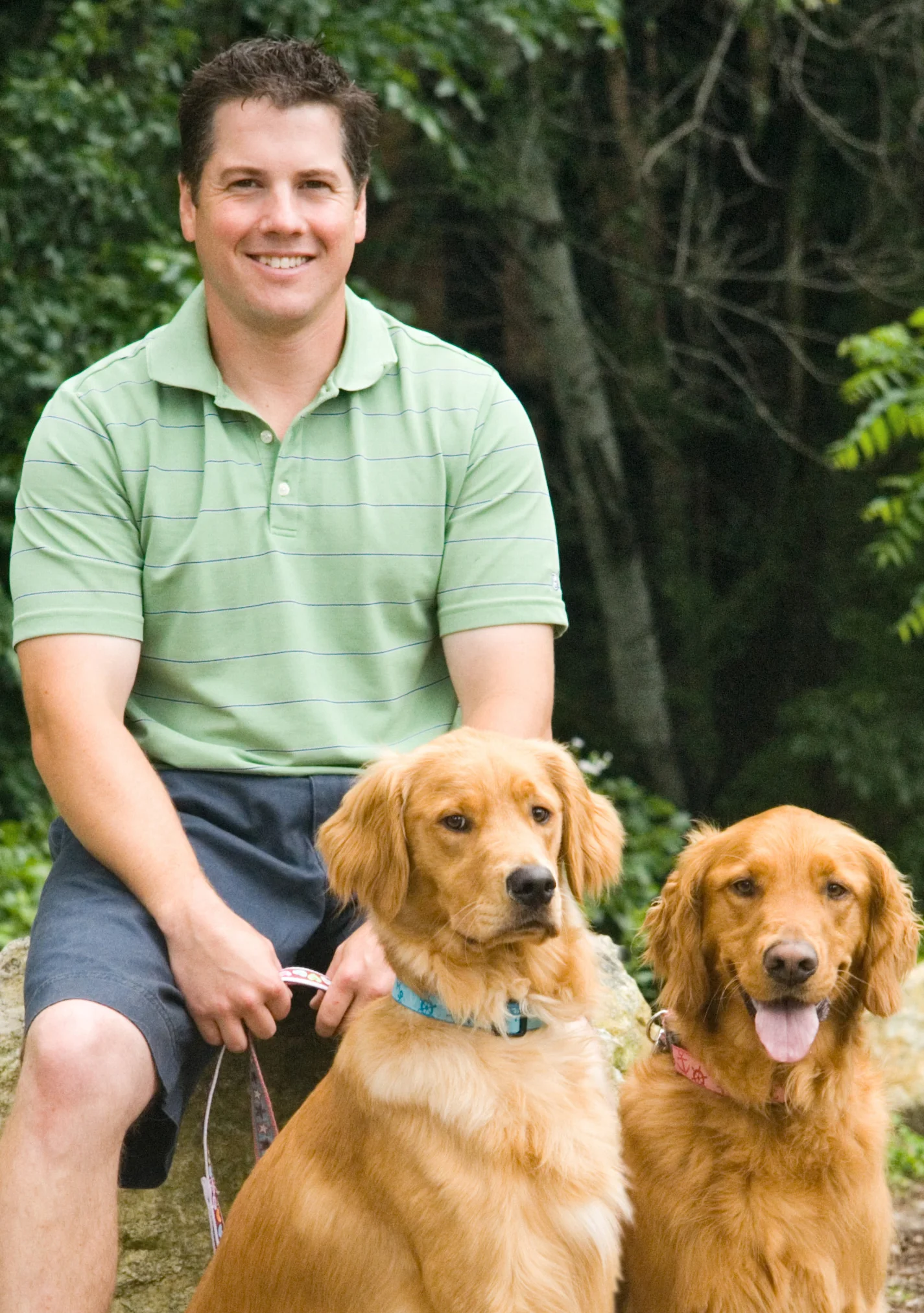 Owner Greg Rousseau, posing with official GPR mascots Moose and Murphy.