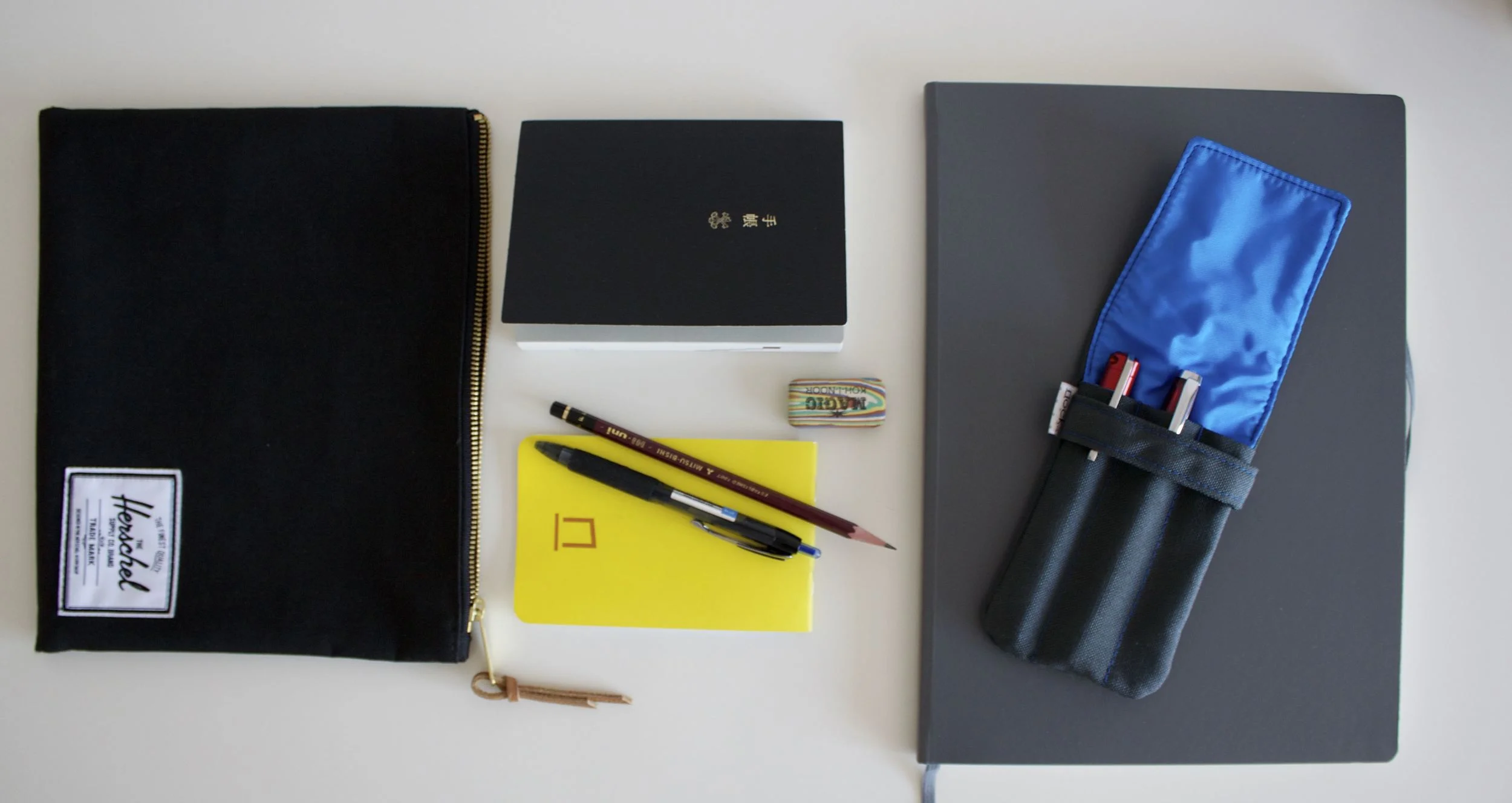 Herschel Supply medium pouch, Hobonichi Techo, Nock Co DotDash pocket notebook, Magic Koh-I-Noor eraser, Uniball Signo 207, Leuchtturm 1917 Master Slim, Nock Co Hightower, TWSBI 580 RB, Karas Kustoms Ink