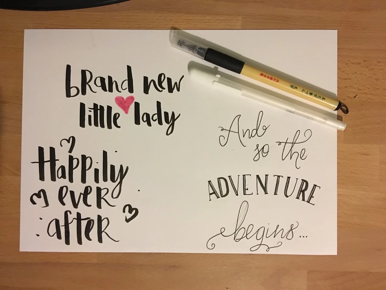 Practicing brush lettering styles for a New Baby card.